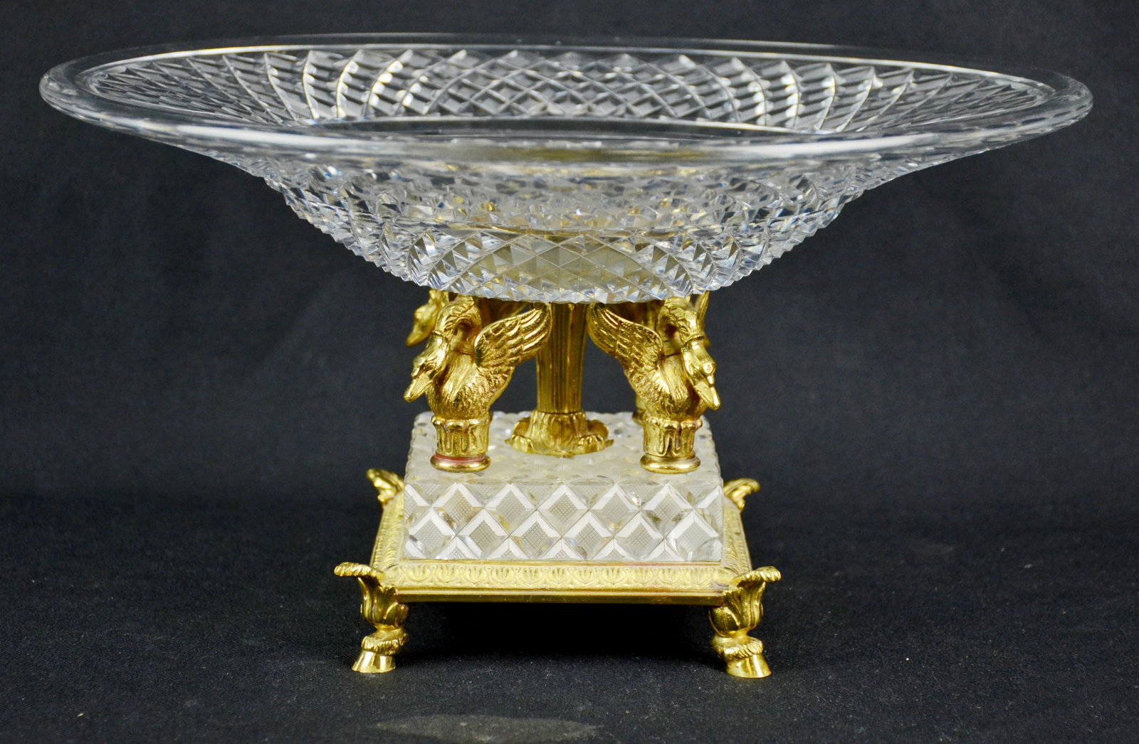 Cut Glass Bowl on Brass Swan Base: Large cut glass bowl on raised brass figural swan center with hoof foot base and gilt medallion center. 15" L 8" h