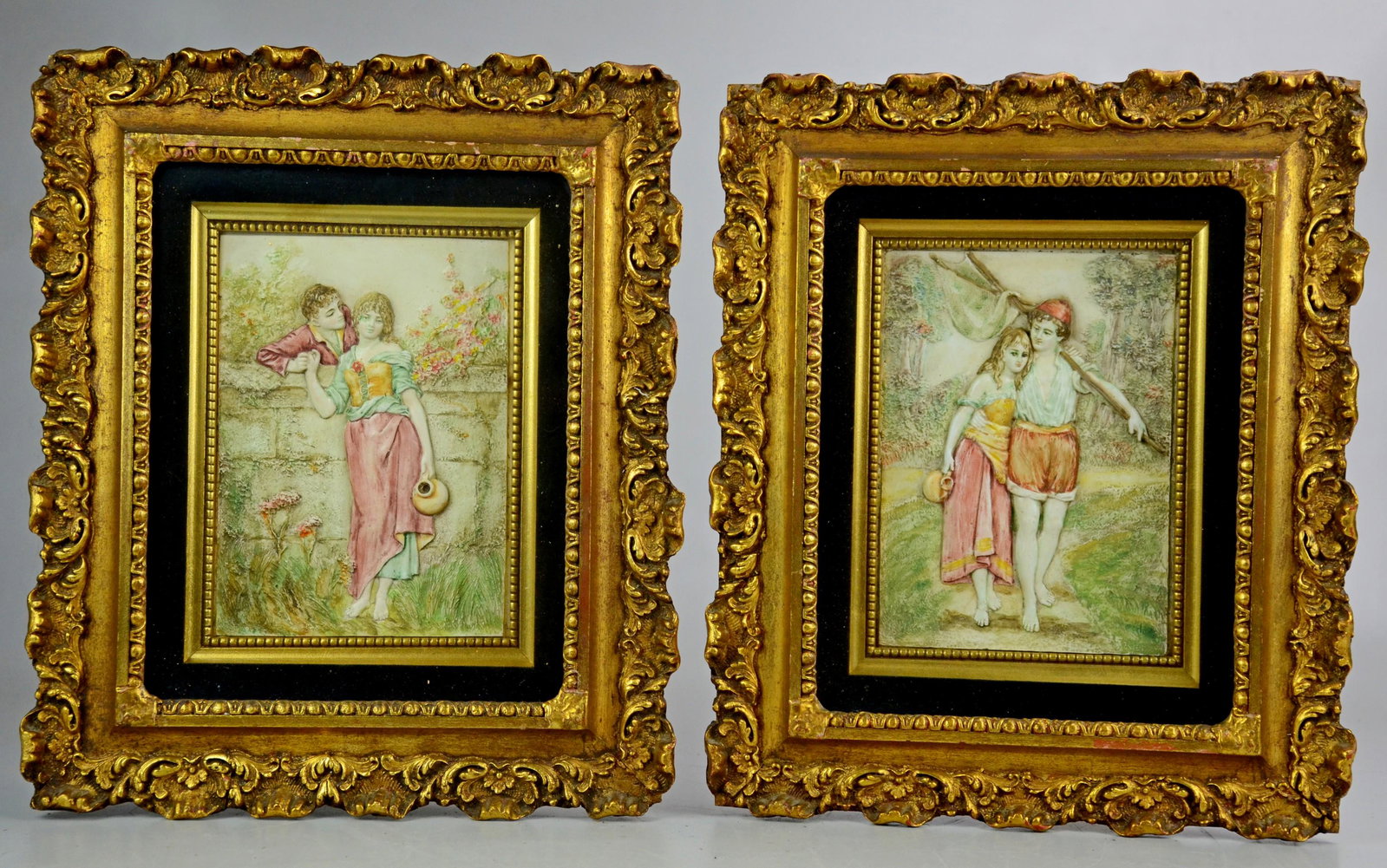 Framed Romantic Plaques: Pr gilt framed shadow boxes containing plaques depicting romantic scenes. Velvet and gold inset framing, 15" h, 12.5" l