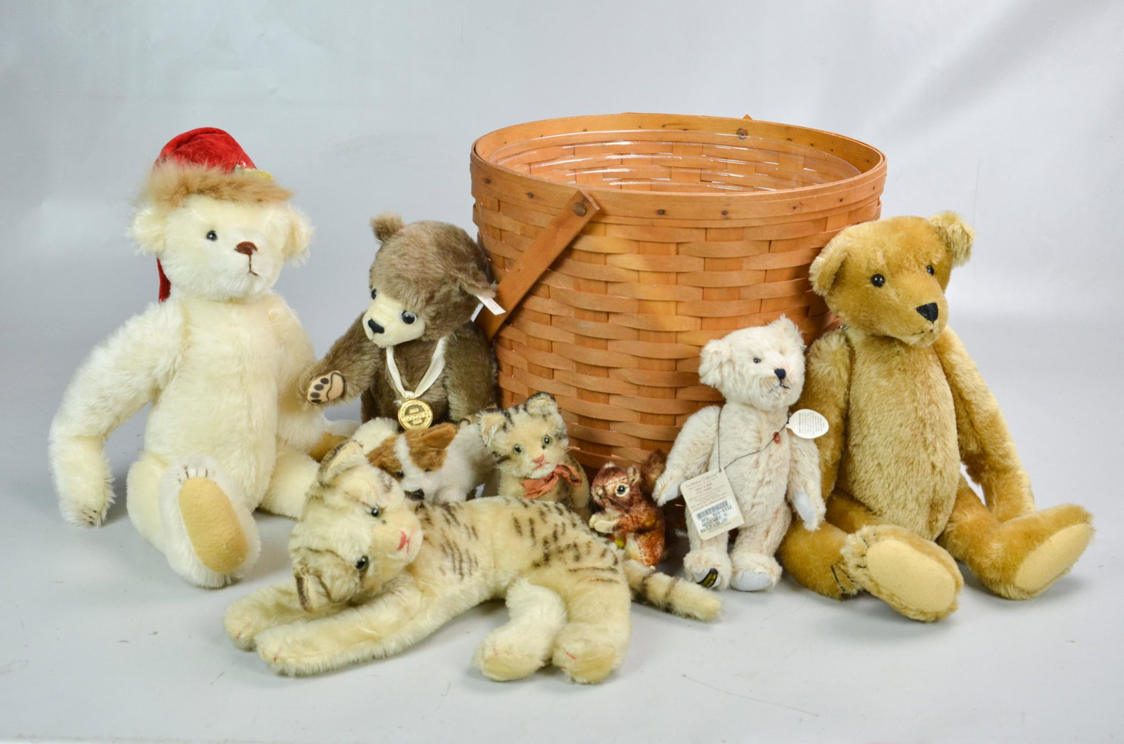 Stuffed Animal Group Including Steiff: Stuffed animal grouping c/o Steiff mohair "Perri" squirrel, (2) Gorham wind up musical jointed bear, 16" h, one with Santa hat, (2) unmarked cats, (1) unmarked miniature dog, (1) Gund bear and (1) Ste