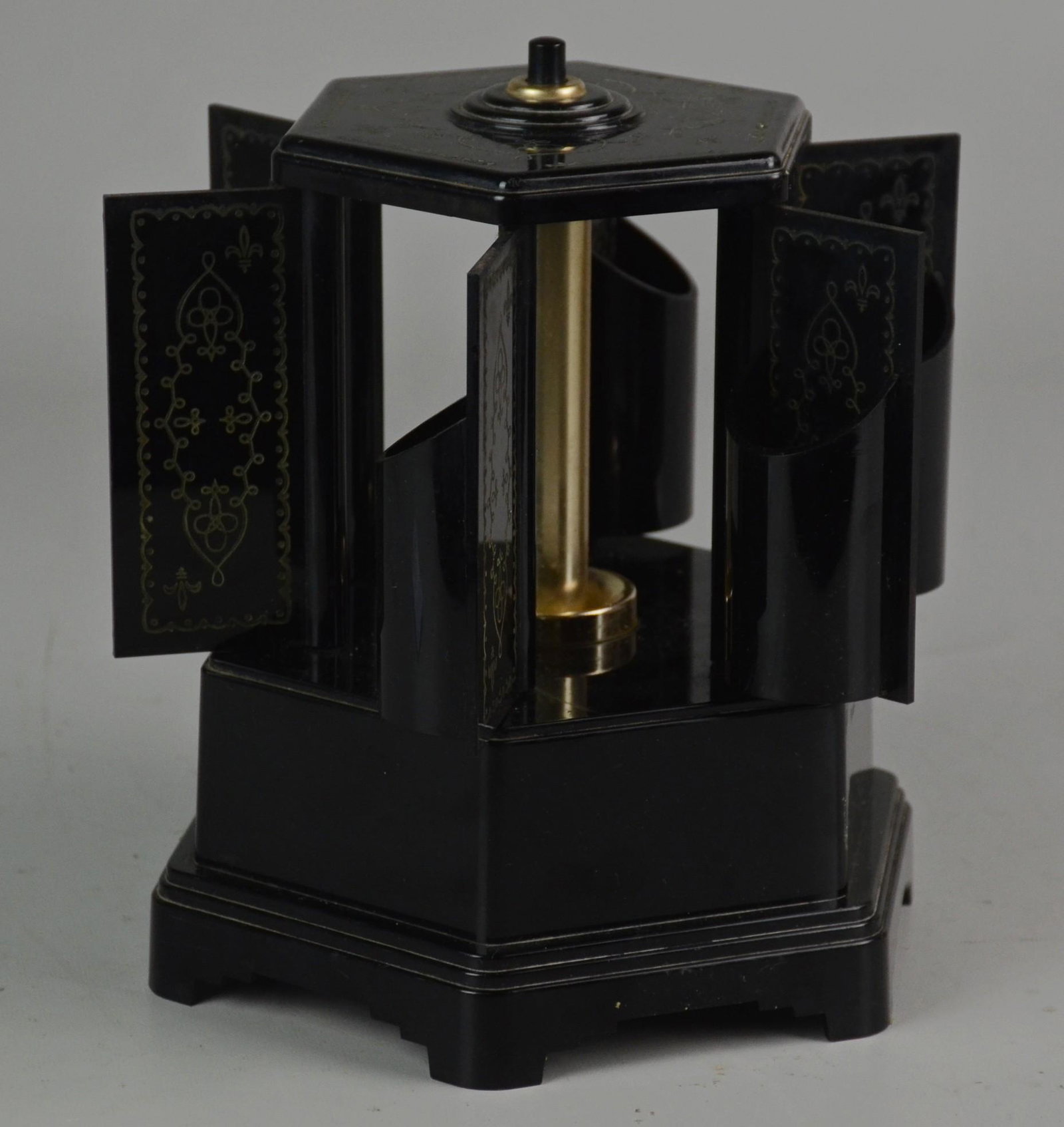 Musical Cigarette Roundelay: Musical cigarette roundelay carousel dispenser, black bakelite with gold decoration, music box works, doors will not open by themselves, but once opened will close, 7-1/2" h