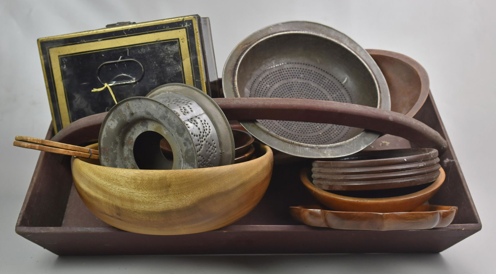 lot of tin and woodware, tin document box: lot of tin and woodware, tin document box, with two tin strainers, large wood implement carrier along with 9 wooden bowls, 4 spoons and a nutcracker, implement carrier 27" x 15"