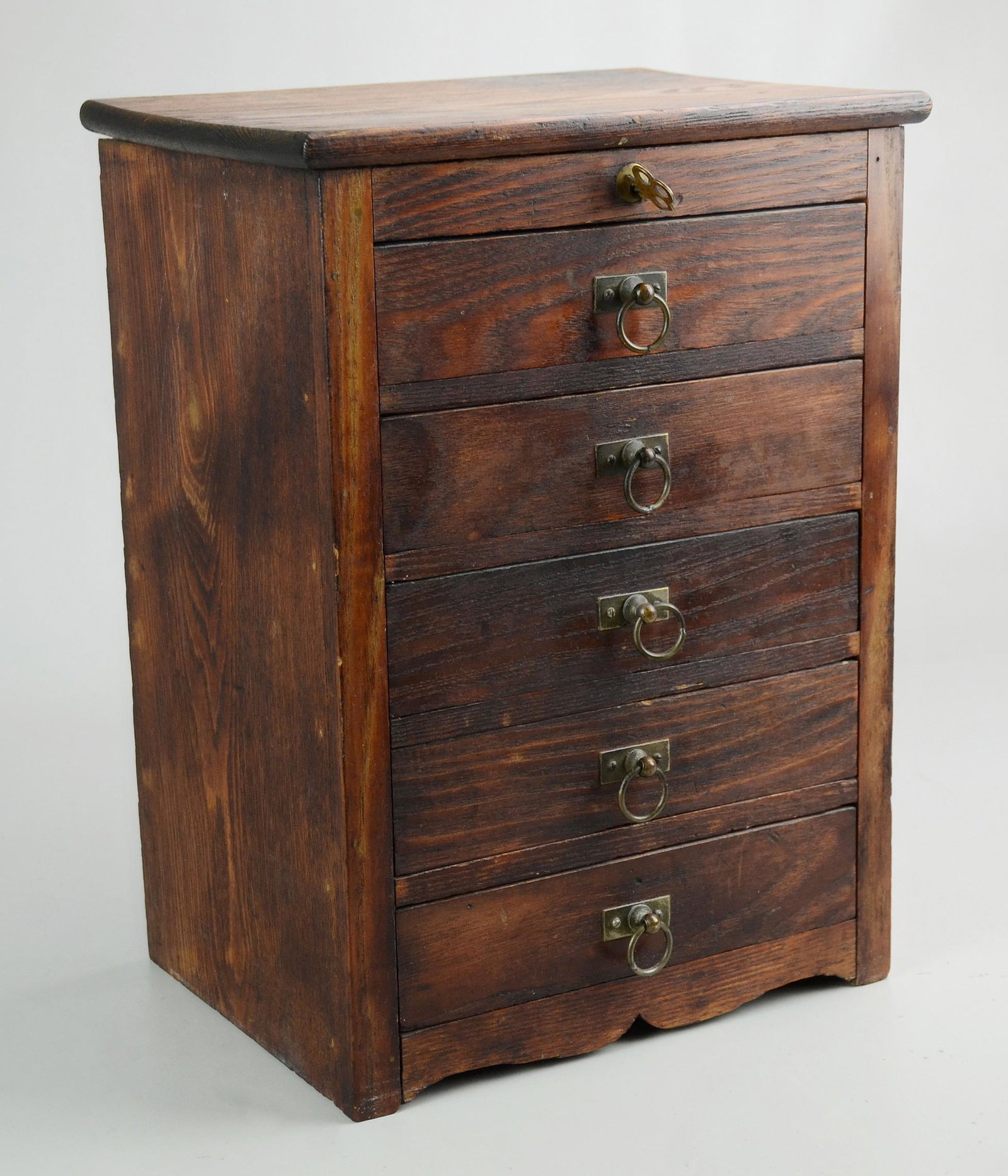 5 drawer pine miniature chest: 5 drawer pine miniature chest, with fitted drawers, all locked by a single key and spring mechanism, 20th c, 10"w x 8"d x 20"h