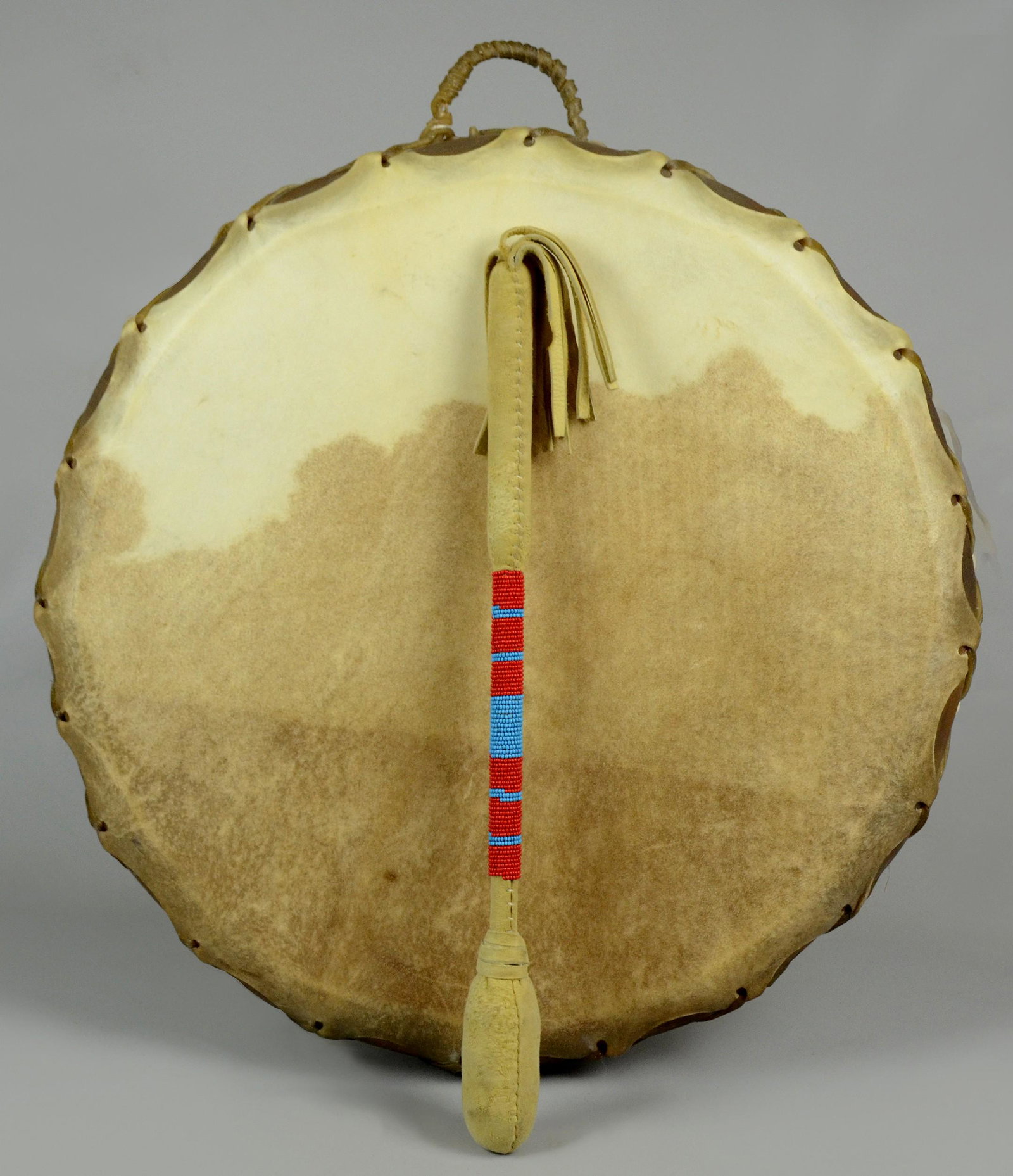 Native American Rawhide Drum & Beaded drum stick: Native American Rawhide Drum & Beaded drum stick. Drum is double sided, approximately 20" diameter. Drum stick / mallet with padded hide tip, 18-1/4" without fringe.