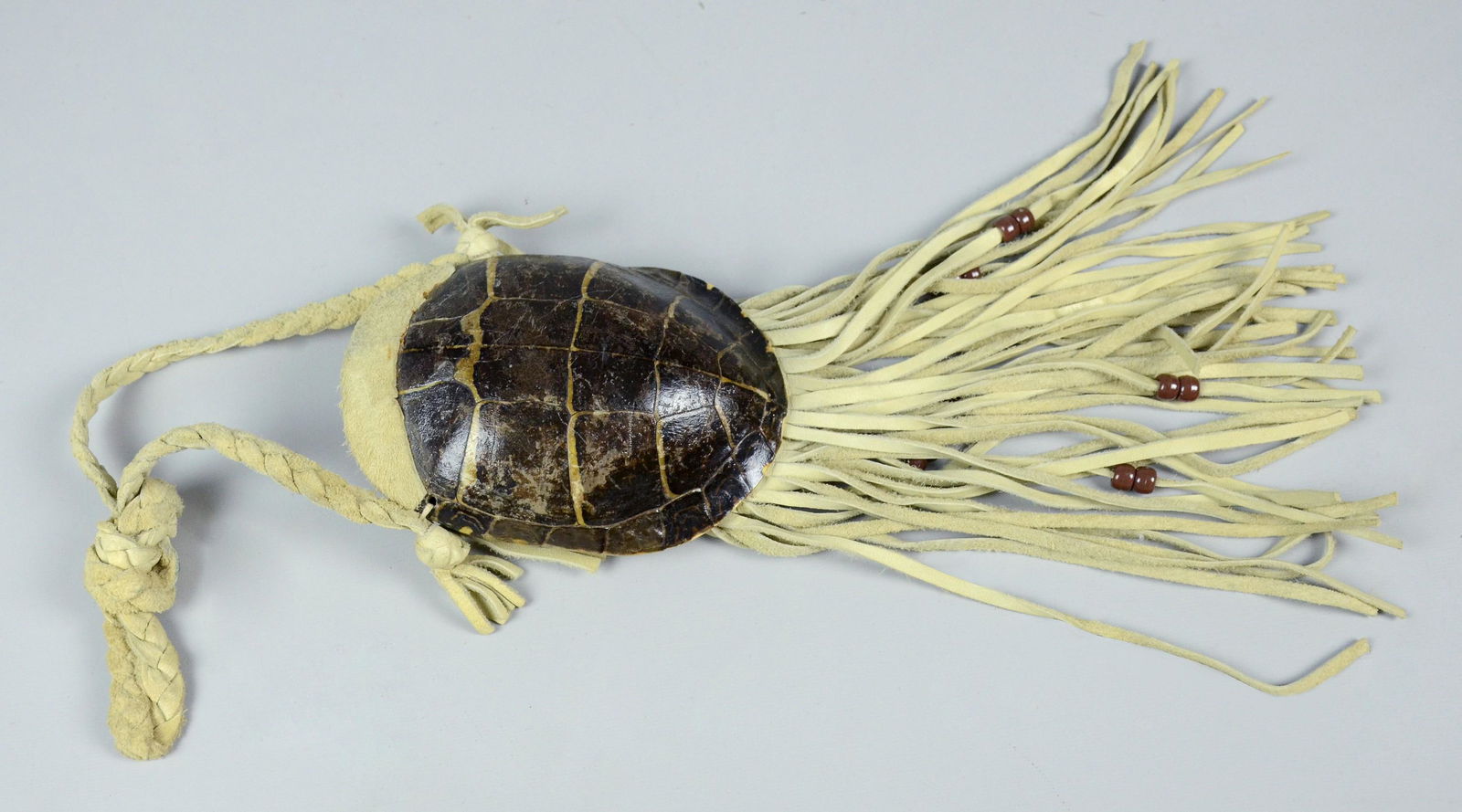 Southwest Native American ceremonial turtle shell: Southwest Native American ceremonial turtle shell medicine bag / pouch, braided hide strap with hide fringe, shell measures approximately 6" L