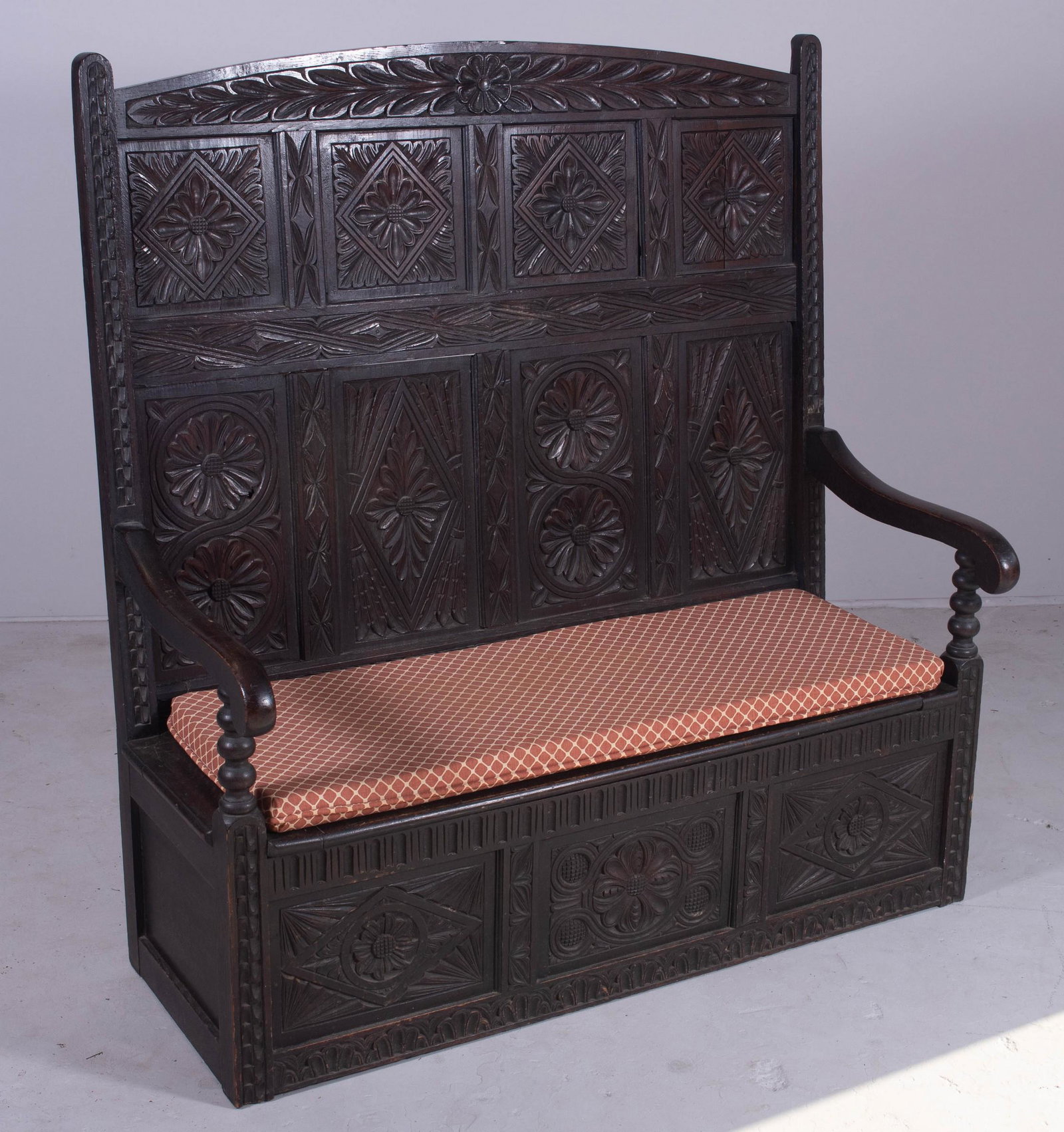 English walnut carved bench: English walnut carved bench, flip up seat with storage, carved floral decoration on back and base, 54" h x 50" w x 24-1/2" d, wear and cracks