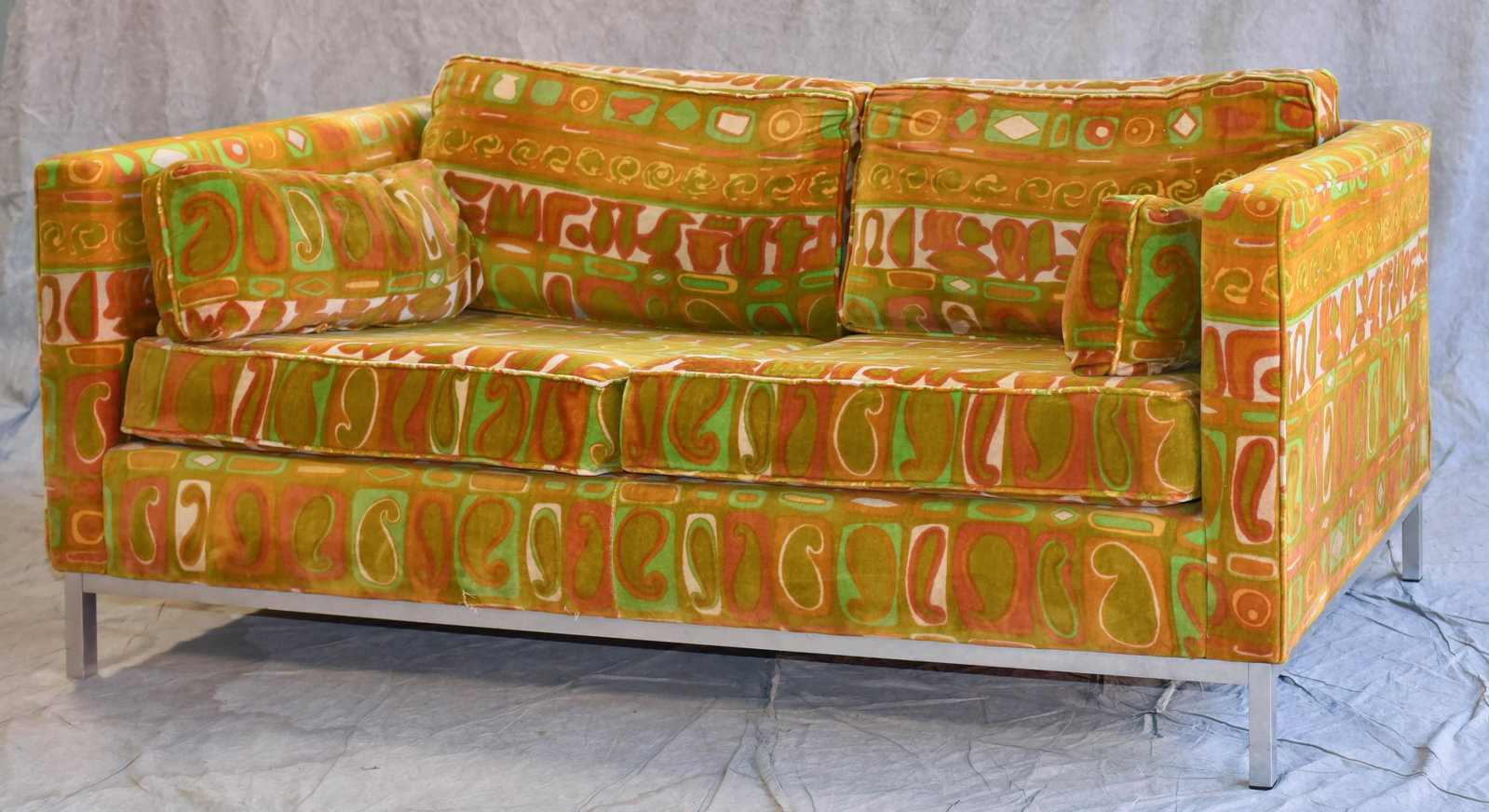 Florence Knoll style chrome sofa: Florence Knoll style chrome sofa, Jack Larsen upholstery with chrome base, 25" h x 65" w x 33" dFading to back of sofa and arm rest covers, bring underneath. Filling of side pillows needs changed; cus
