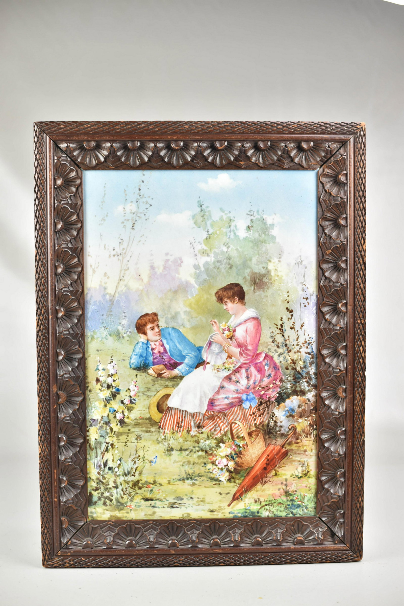 Hand Painted Porcelain Plaque: Manuel Garcia y Rodriguez (Spain, 1863 - 1925) hand painted porcelain plaque, couple in garden, signed M Rodriguez Sevilla 1890, in a carved aesthetic style frame, tile 19" x 12-3/4", 23-1/2" x 17-1/4