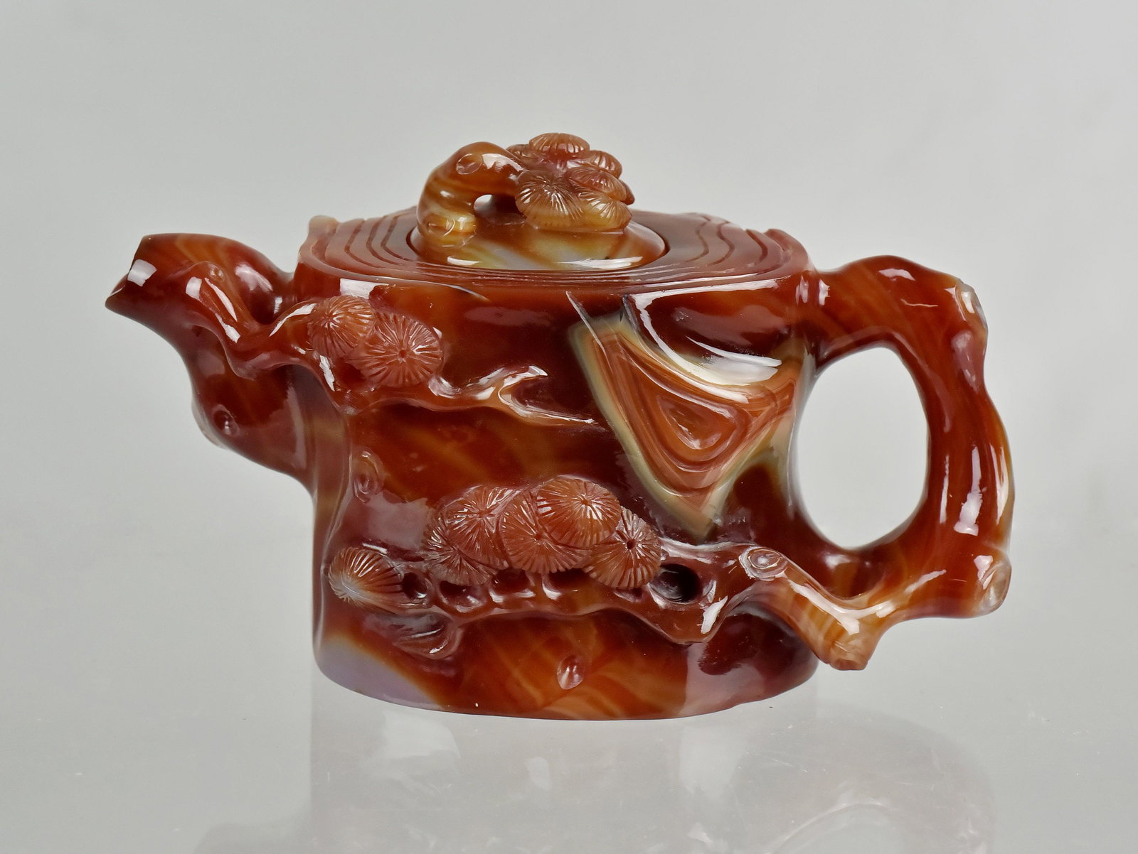 Chinese Carved Carnelian Teapot: Chinese carved carnelian teapot w/pine tree decoration, 4" h