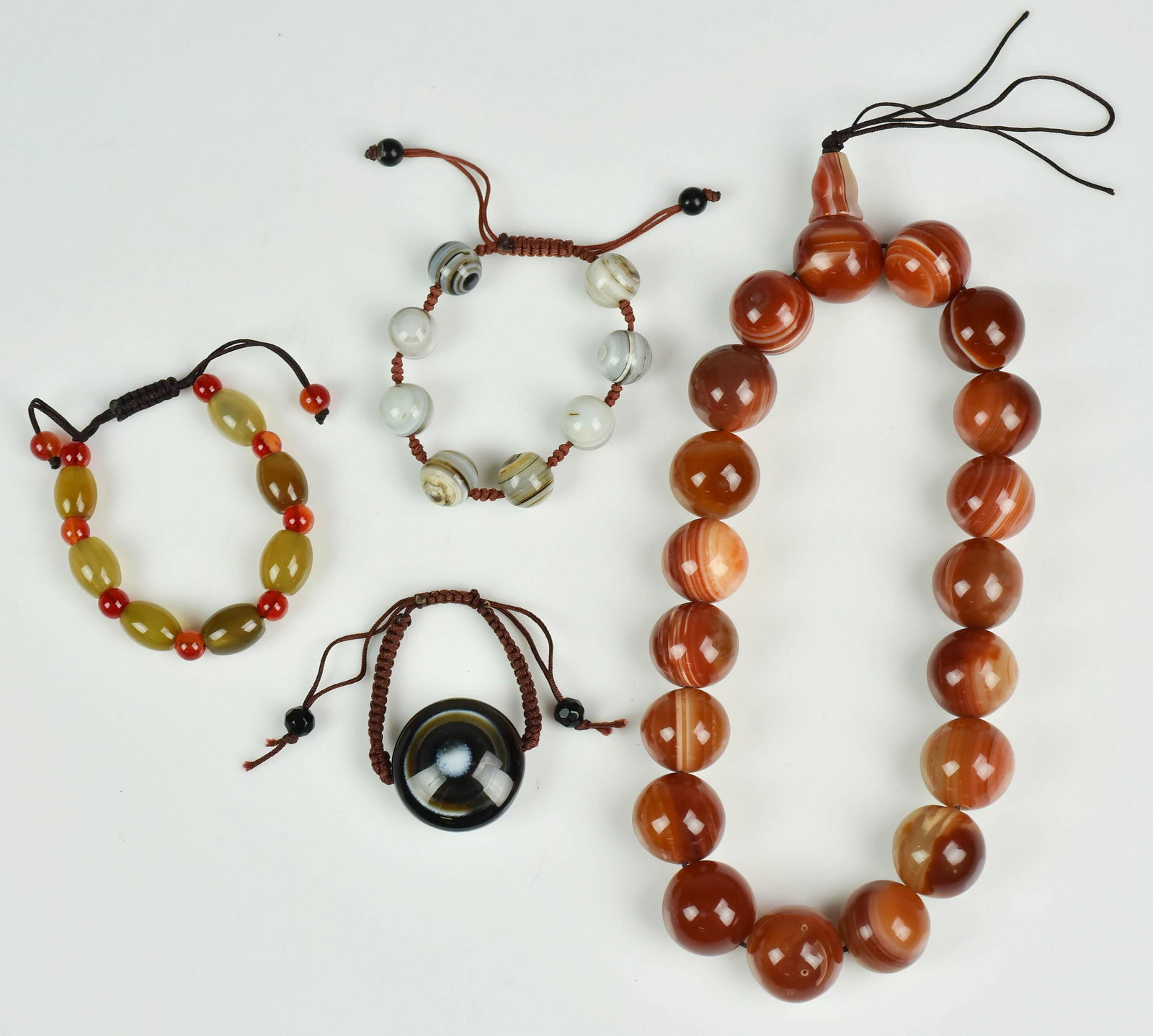 (4) Chinese Carved Stone Pcs. Jewelry: (4) Chinese carved stone pcs. of jewelry c/o carnelian necklace, 2 stone bracelets and agate "Eye"