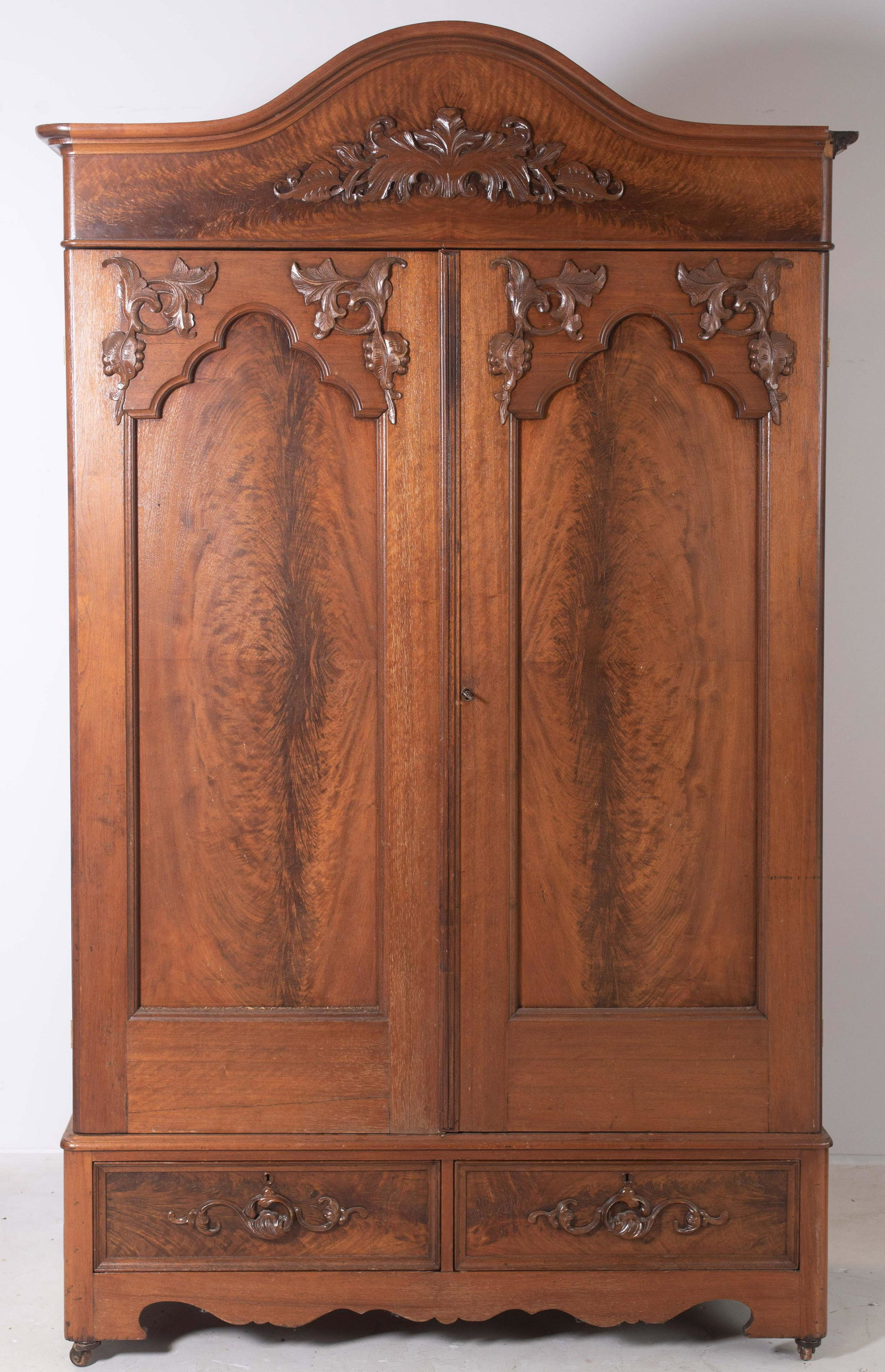 Walnut Victorian armoire: Walnut Victorian armoire, carved crest, 2 doors with applied carvings over 2 drawers, 54"w x 95"tall, top right cornice corner block missing