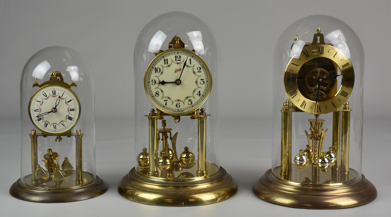 (3) Anniversary Clocks: (3) Anniversary clocks, brass with glass dome, c/o Schatz made in Germany, S Haller one jewel made in Germany, Euramca Trading Co made in Germany, largest 11-1/2" h x 7-3/4" dia, all in running condit