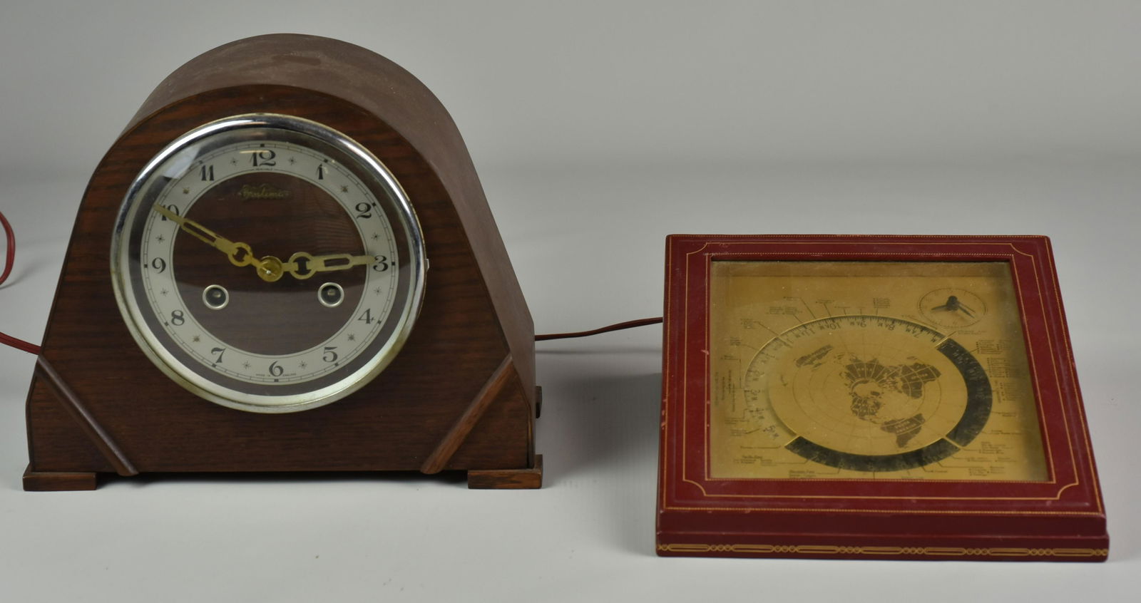 (2) Mid-Century Clocks: (2) Mid-century clocks, c/o Kalex Corp International Time Clock, electric, leather case, rotating dial with major cities of the world, 8-1/2" w x 9-3/4" d x 3-3/4" h, Bentima Perivale Art Deco style,