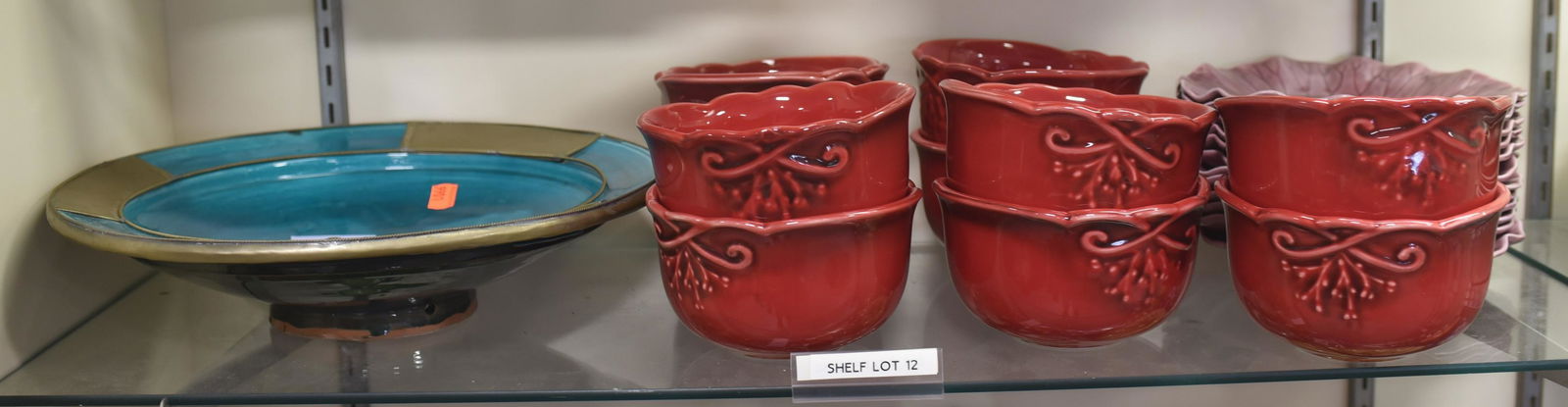 Shelf #12 - Ceramic Dishes and Bowls: Shelf #12 - (10) Red Nocal Portugal Bowls, (12) Plum Lotus Metlox Ruffled Dishes (8-1/2" Dia), (1) Blue Morocco Center Bowl with Brass Accents to Rim (13-1/2" Dia)