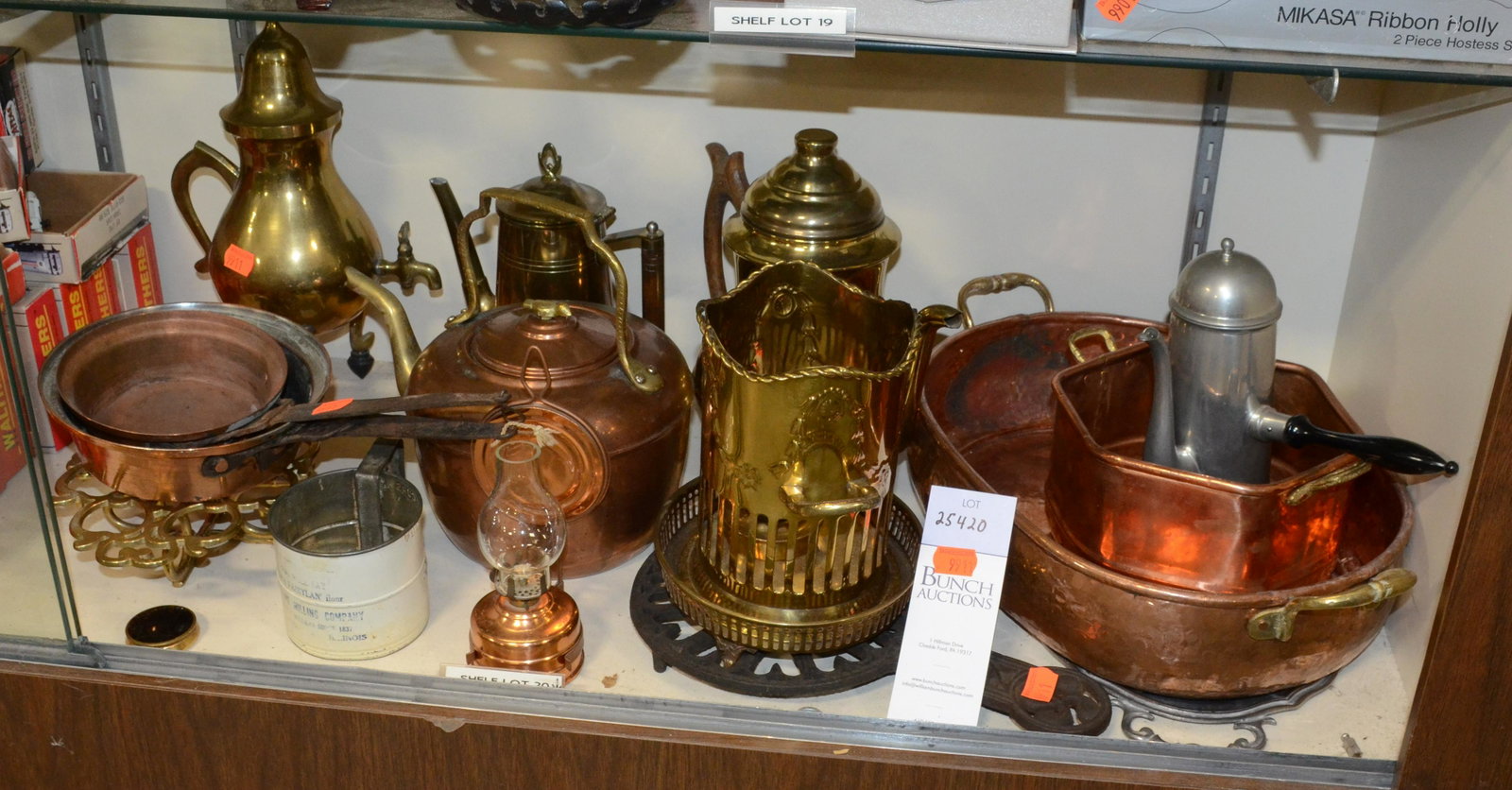 Shelf #20 - Copper and Brass Lot: Shelf #20 - Copper Items Including: Teapot, Small German Oil Lamp with Reflector, (2) Pans with Wrought Iron Handles, (2) Pots, Brass Items Including: Wood Handled Teapot, Indian Candle Holder, Small 