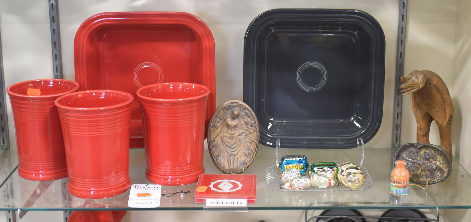 Shelf #69 - Christmas Ornaments and Collectibles: Shelf #69 - Christmas ornaments and collectibles c/o (3) Fiestaware HLC USA red crocks, (2) Fiestaware HLC USA baking pans, ornaments c/o (2) trolley cars, (2) miniature santas,(1) jester and (1) holl