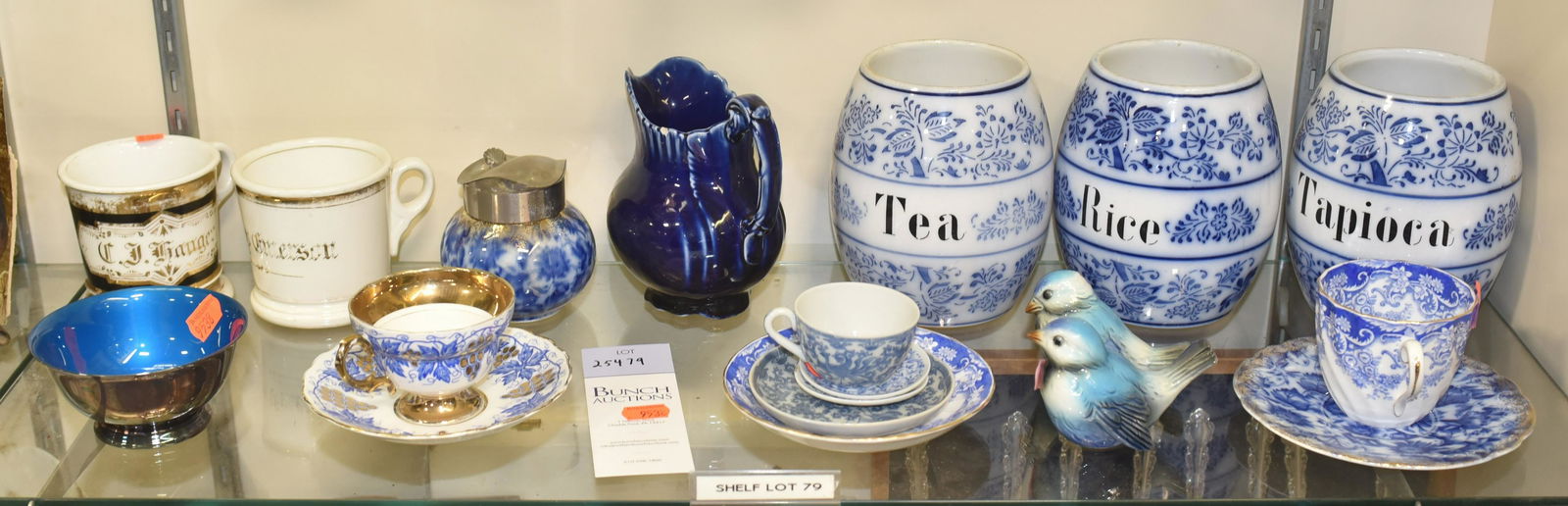 Shelf #79 - Porcelain Including Blue Canisters: Shelf #79 - Porcelain Including: German Blue Onion Canisters (Tea, Rice, and Tapioca), (2) Shaving Mugs Including Limoges, Reed and Barton Blue Enameled Bowl, (2) Goebel Birds, Creamer, Warwick Creame
