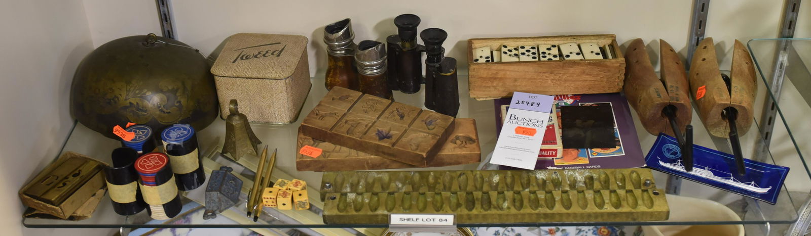 Shelf #84 - Binoculars and Brass Mold: Shelf #84 - (2) Binoculars Including: Paris Jockey Club, Carl Zeiss Jena Binoculars, Carved Wood Animal Molds, Bone Dominos, Graduated Bells, Brass Bullet Molds, Shoe Stretchers, Tintype
