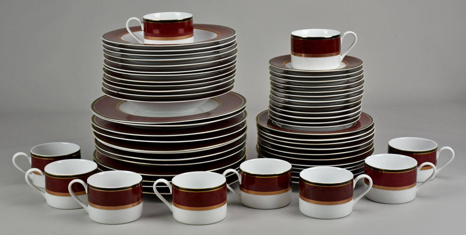 (57) Piece PTS International Interiors Fifth Ave Ruby: (57) Piece PTS International Interiors Fifth Ave Ruby Dinnerware Including: (12) Dinner Plates, (11) Salad Plates, (12) Soup Bowls, (10) Teacups, (12) Saucers