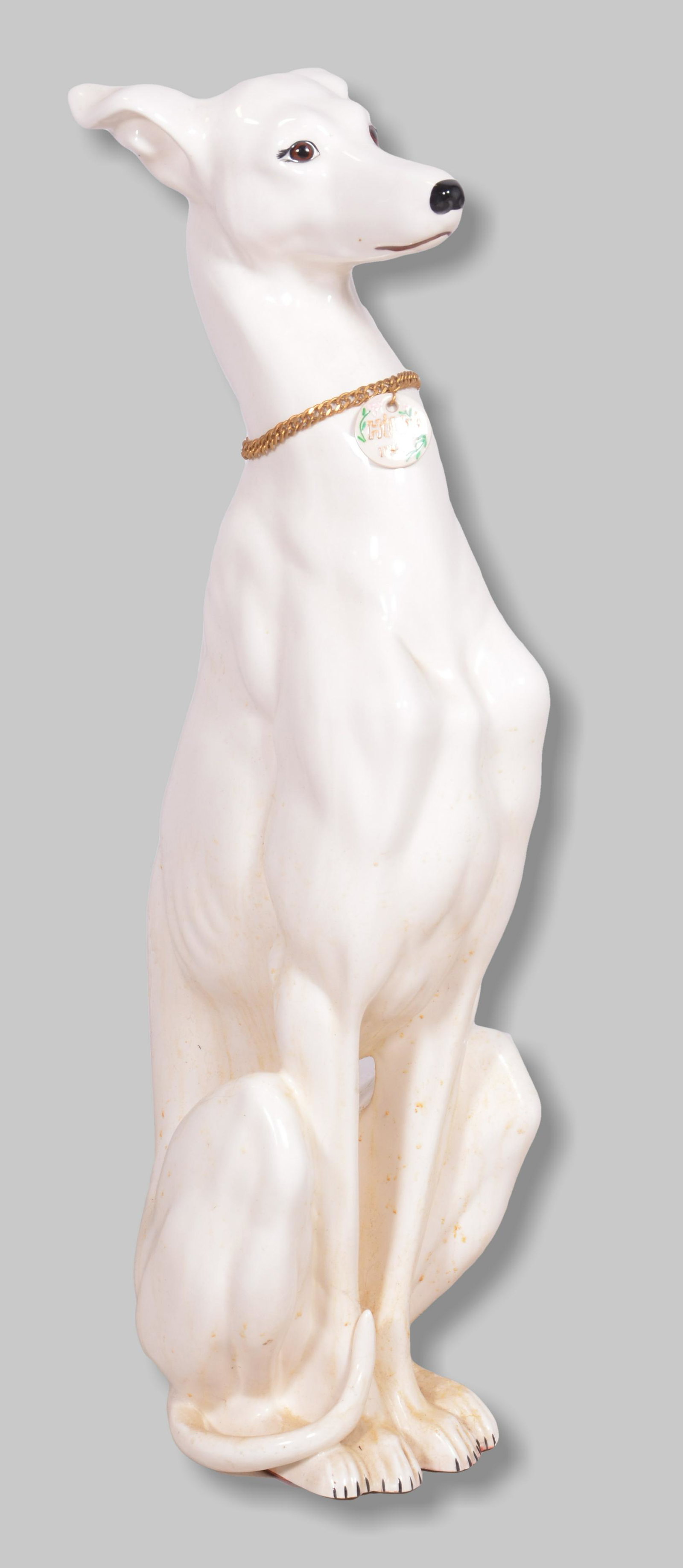 Porcelain statue of a Greyhound: Porcelain statue of a Greyhound, tag states "Hilda 1142", 28"h