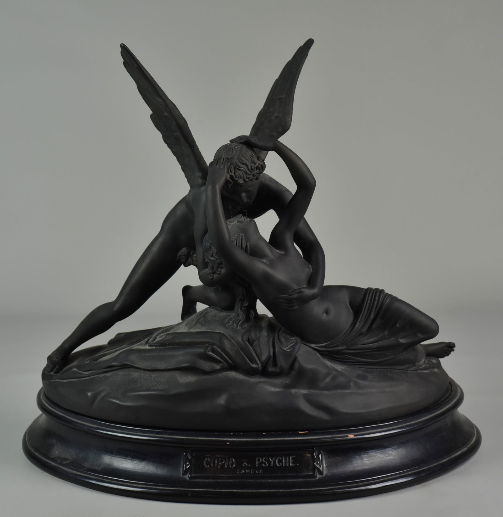 Canova Cupid & Psyche Sculpture: Cupid and Psyche pottery sculpture after Antonio Canova (Italian 1757-1822), depicting a recumbent Psyche held in Cupid's embrace, her face lifted for his kiss, on a custom redware demi-lune form step