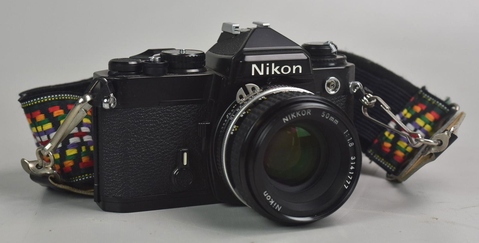 Nikon FE with 50mm 1:1.8 prime lens: Nikon FE 35mm SLR film camera with Nikkor Ai-S 50mm 1:1.8 prime lens. In great cosmetic condition, camera is not battery tested though shutter fires at M90 setting and self timer works.