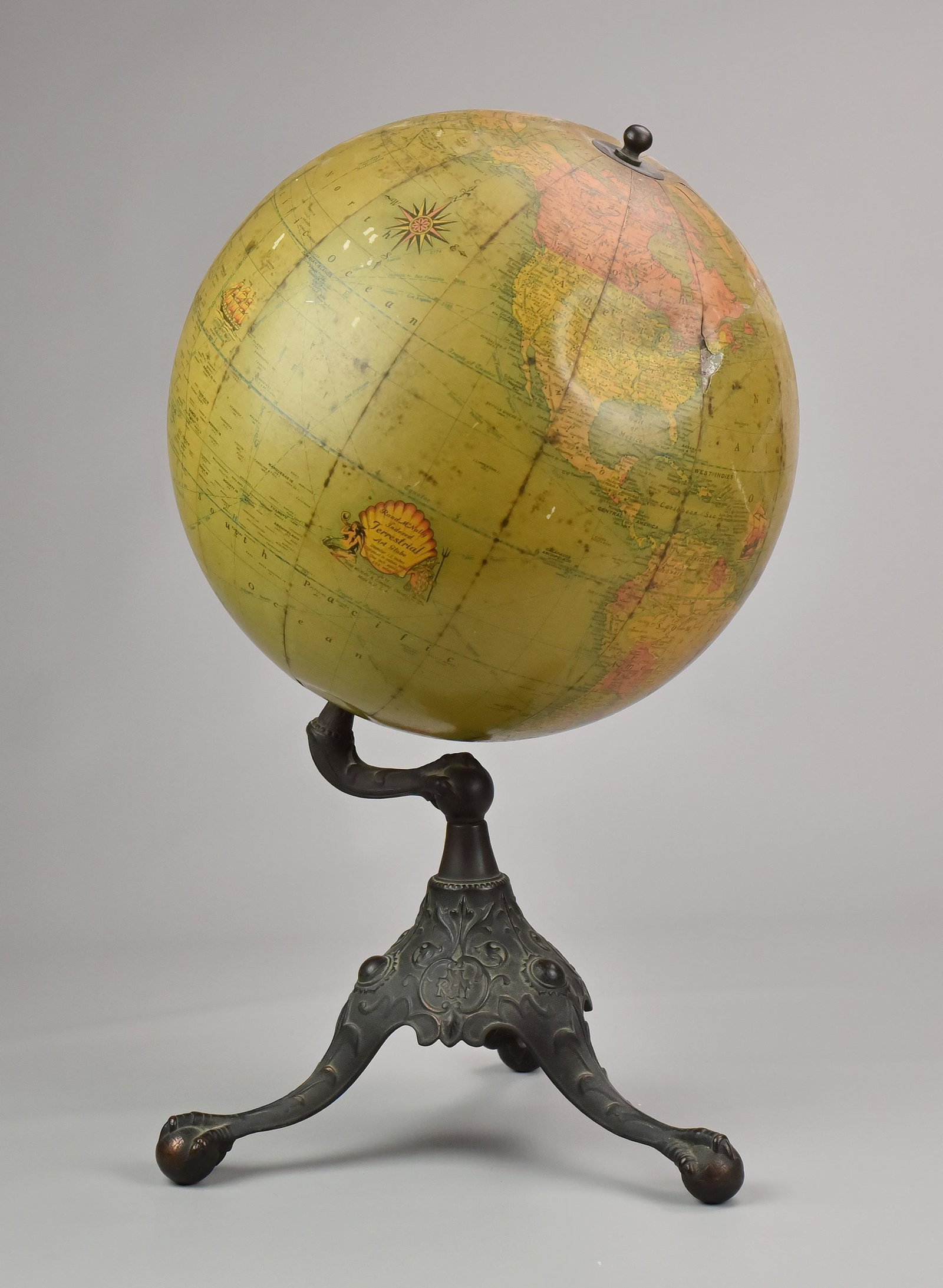 Rand McNally Terrestrial Globe: Rand McNally Indexed Terrestrial Art Globe, cast iron base with claw & ball feet, early 1900s, globe 12" dia, 20" h, globe with dents, stains and paper chipping