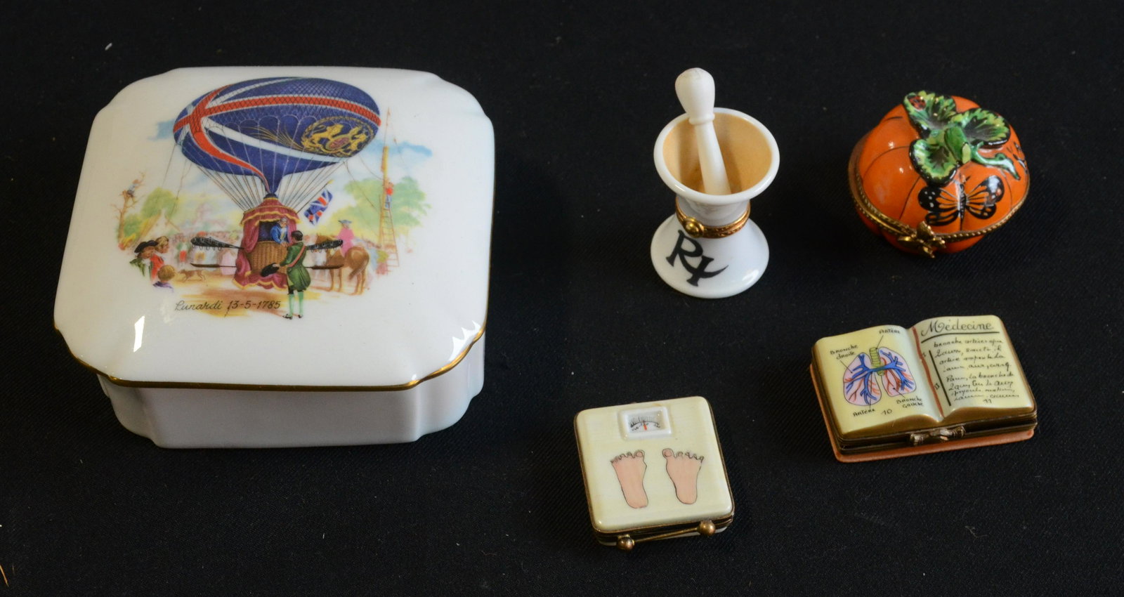 (5) Limoges Boxes: (5) Limoges boxes c/o Lunardi dresser box, 5.5", mortar and pestle trinket box, Rochard pumpkin trinket box with loose hinge, figural scale trinket box and medical text trinket box.