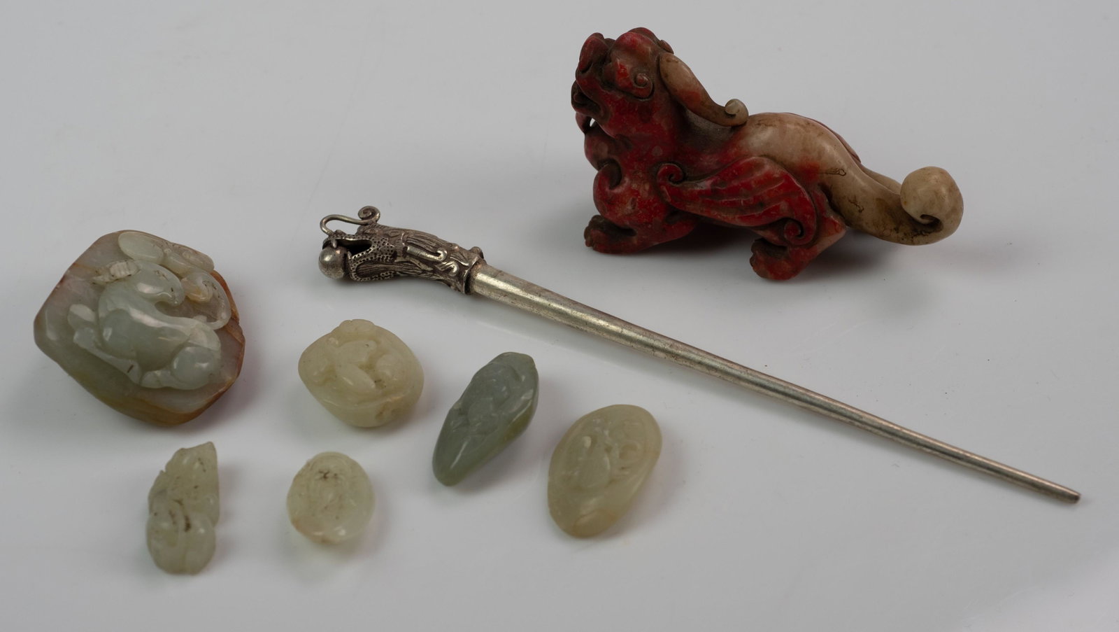 (8) Chinese Pcs.: (8) Pcs. Chinese pcs. c/o pebble jade w/ram, (5) hardstone carvings, soapstone shoushan mythical creature and silvertone hair pin w/dragon, largest 8" long