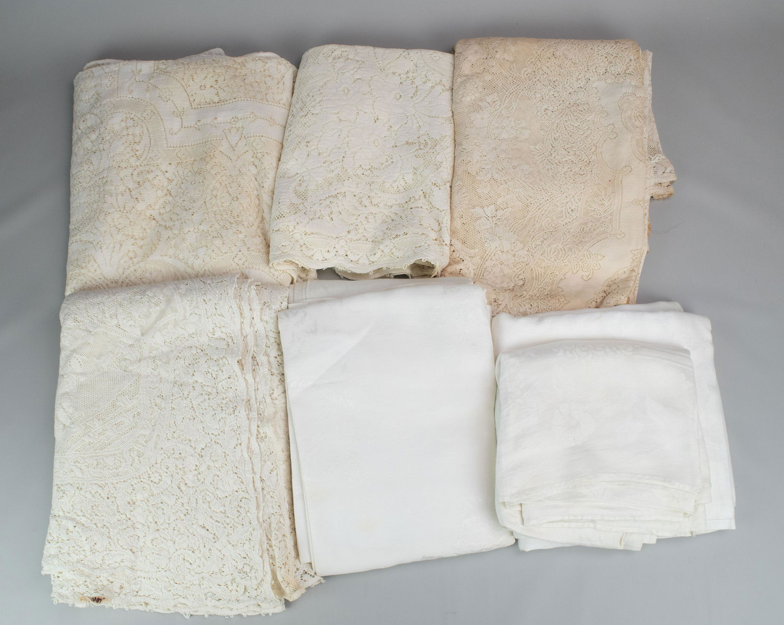 (4) Quaker Lace Tablecloths: (4) Quaker lace tablecloths, (3) with loops. Grouping also includes (5) cotton tablecloths.