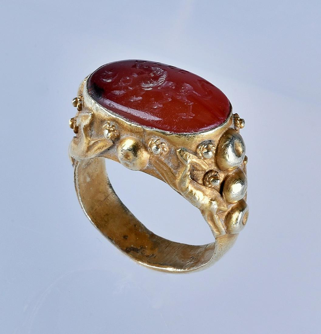 Yellow Gold Carnelian Ring: Unmarked yellow gold carnelian ring, top of stone with intaglio carved lion gardant gazing at crescent moon. (Size 7), (4.8 Dwt Total Weight)