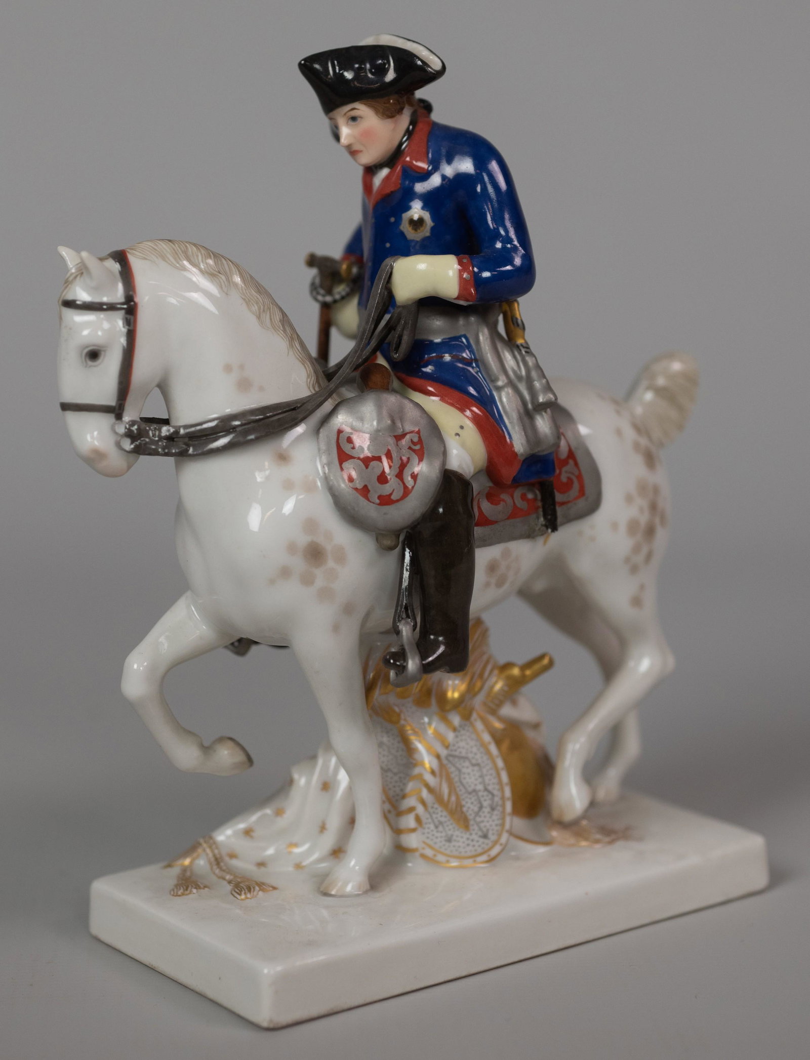 KPM Porcelain Military Figurine on Horseback: KPM porcelain figurine, German military soldier on tricorn hat on horse, shield & armor under horse, cane broken, 6" h x 5" w