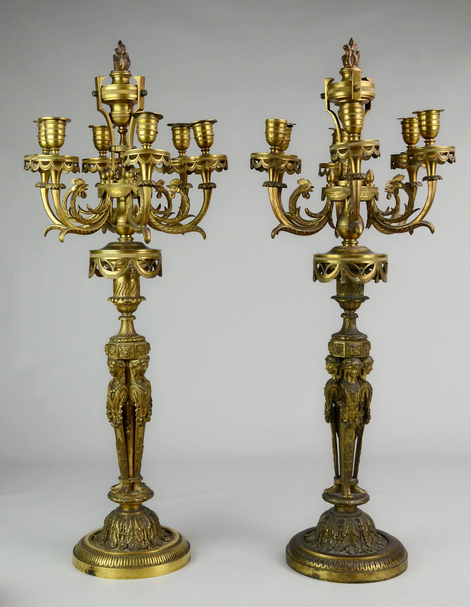 Pr Gilt Cast Bronze Figural Candelabra: Pr French gilt cast bronze figural 6-arm candelabra, base with cluster of 4 garland draped female figures, on a round stepped base with acanthus leaf designs, the top with floral swags under a 6 branc