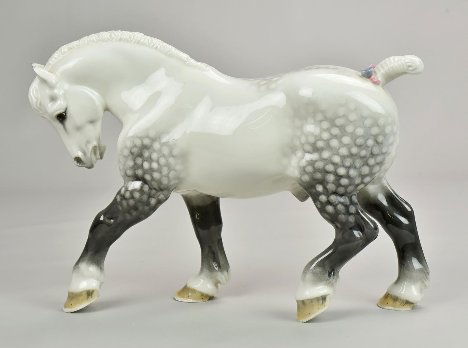 Boehm Percheron Stallion Porcelain Figurine: BOEHM PERCHERON STALLION GLAZED PORCELAIN, 1950, Made by Edward Marshall Boehm. Signed in script on the foot of the Stallion by Boehm; a dapple, glazed with pink and blue ribbon. a rare early figure m