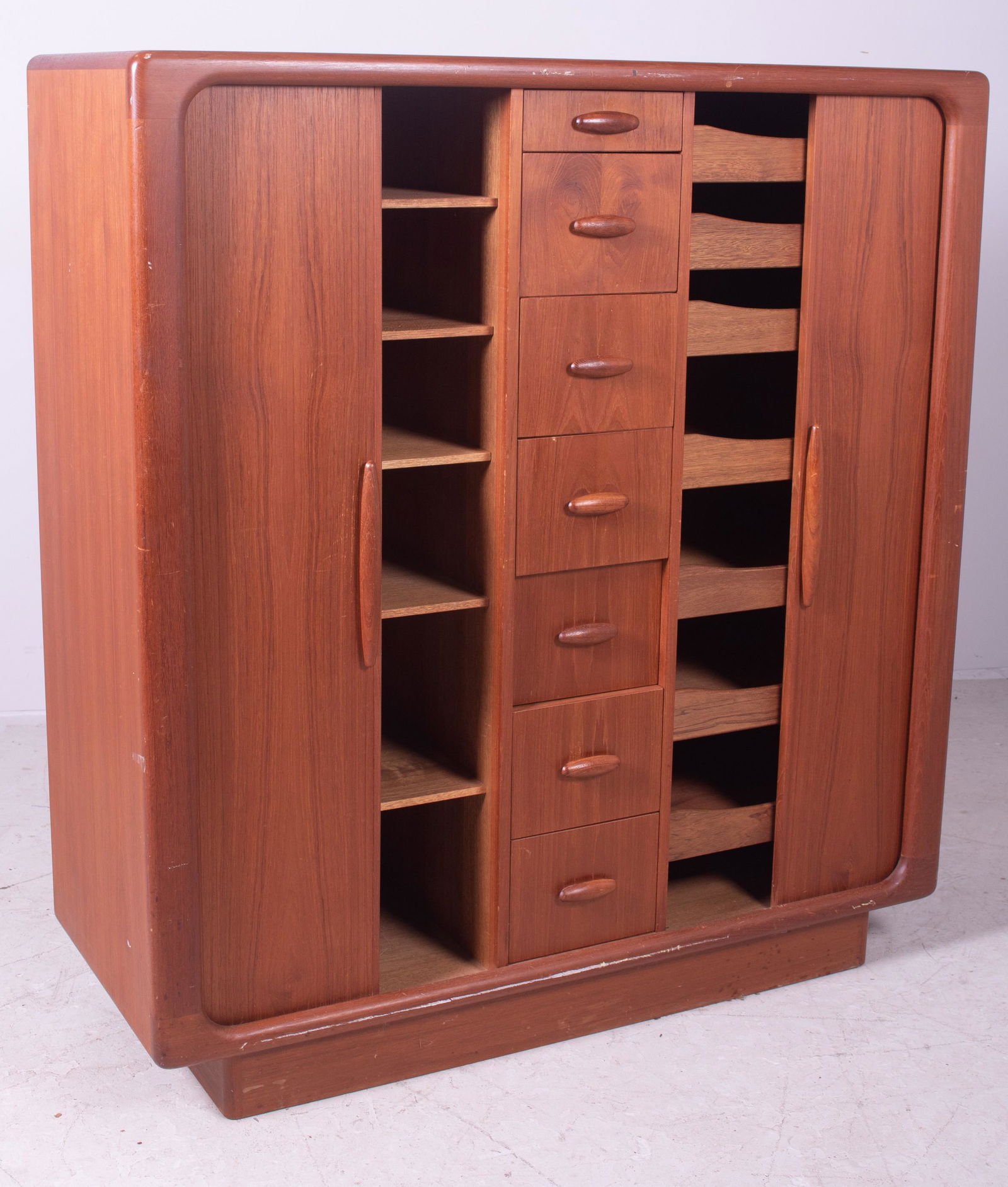 Dyrlund Modern Design teak wardrobe: Dyrlund Modern Design teak wardrobe, tambour doors with one side with drawers and one with shelving, center with drawers, 52" h x 48" w x 19-1/2" d, wear and scratches