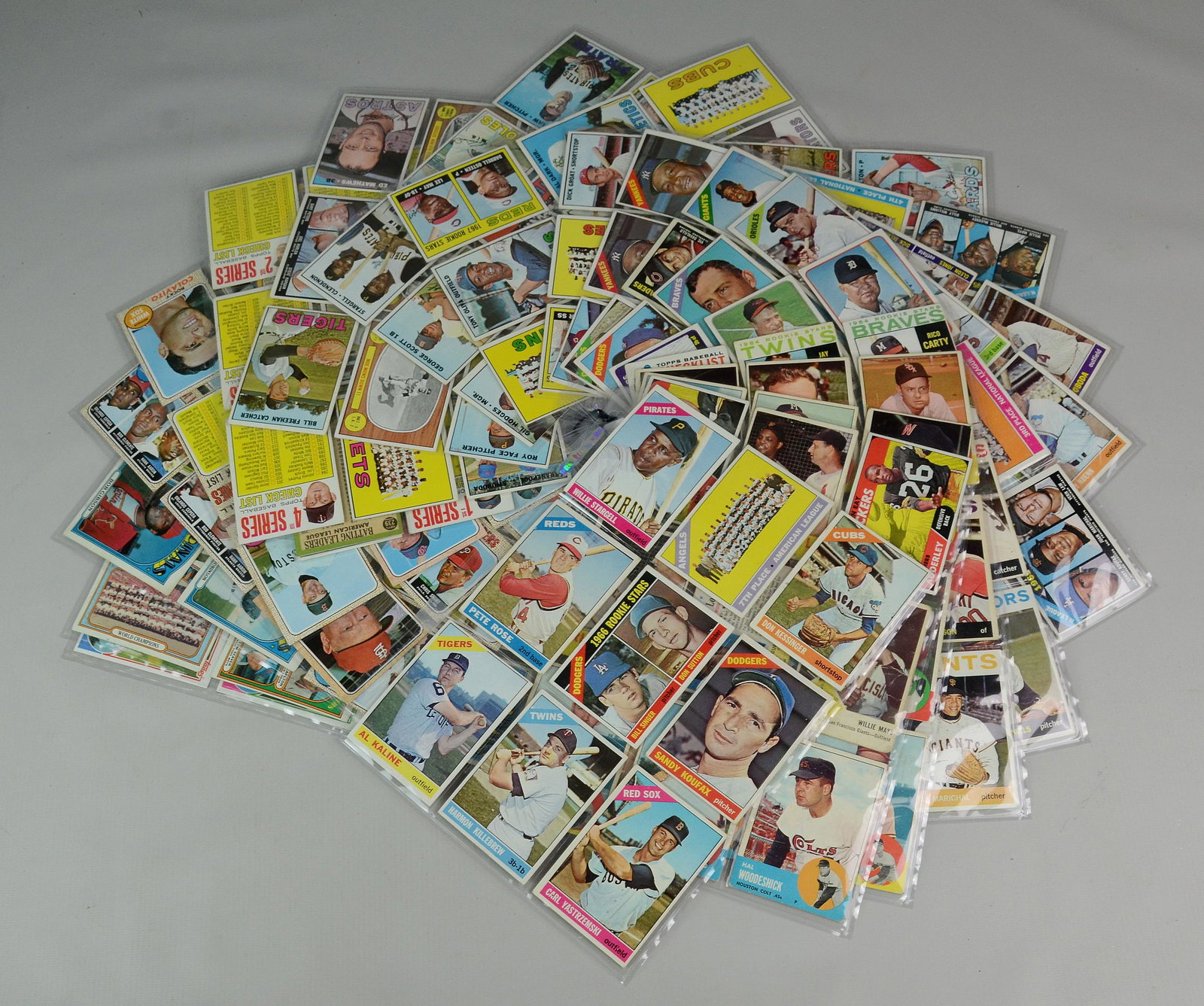 Assorted Baseball and Sports Cards: Various 60's, 70's primarily baseball stars, contained in 21 plastic sheets, including 64 Ford, Killeberew, Frank Robinson, 66 Hunter, Rose, Sutton, Koufax, 1967 Kaline, Frank Robinson, 1968 Carew, Br