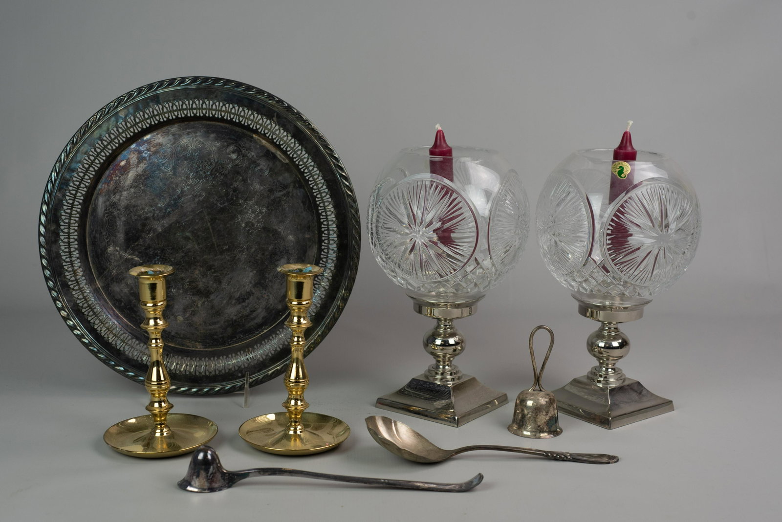 Mixed Lot Waterford, Silver Plate: Mixed Lot, c/o pair of Waterford hurricane lamps with cut glass globe shades, pair of Baldwin brass candlesticks, silver plate reticulated tray, bell, serving spoon, & candle snuffer