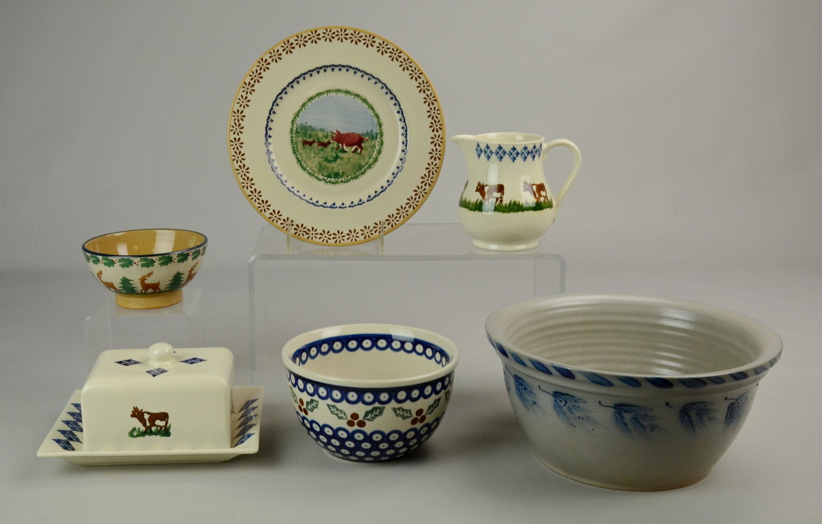 (6) Pcs Pottery: (6) Pcs pottery, c/o Brixton Pottery cow butter dish & creamer, Boleslawiec bowl handmade in Poland, Nicholas Mosse spongeware plate with pigs & bowl with reindeer, Eldreth Pottery 1997 salt glazed mi