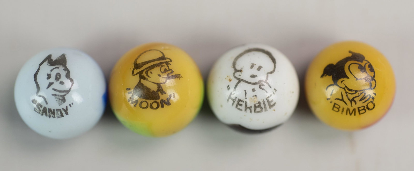 (4) Peltier Company Character Marbles: (4) Peltier Company Character Marbles Including: Sandy, Moon, Bimbo and Herbie