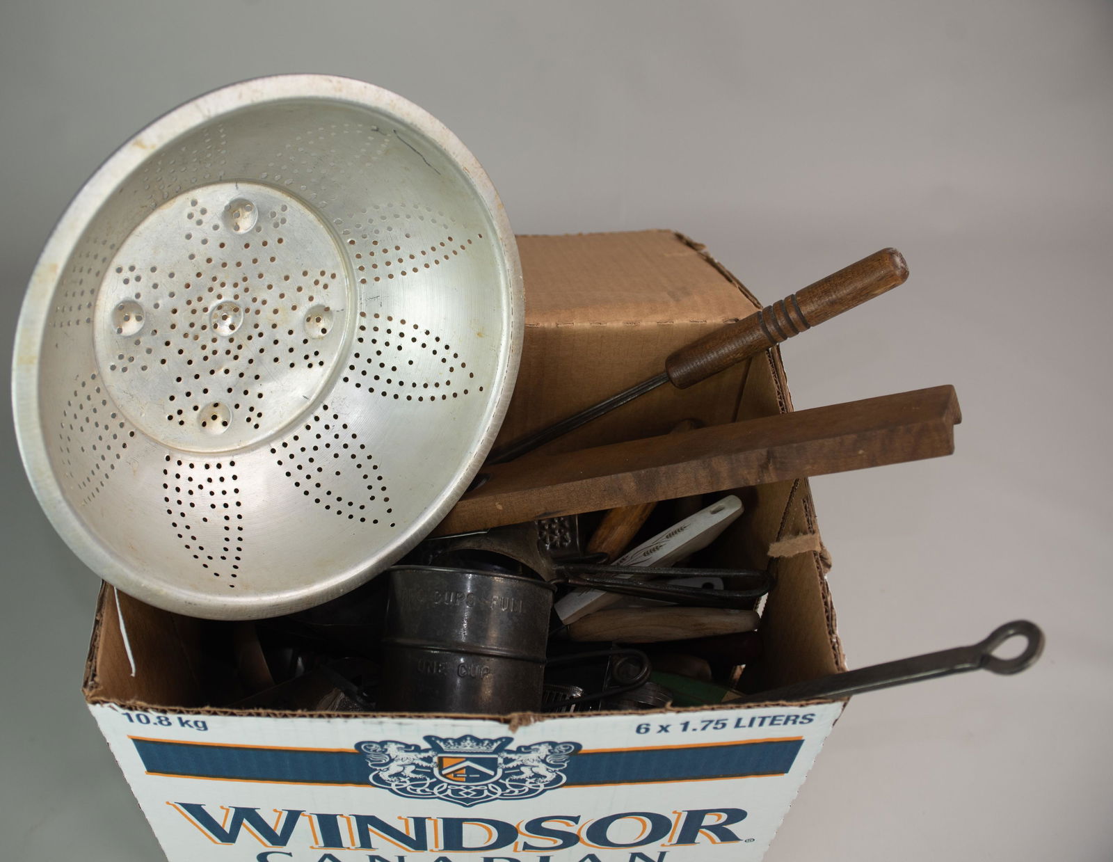 Large Lot of Vintage Kitchen Items: Large lot of vintage kitchen items, including colander, cast iron molds, grater, utensils, Santa chocolate mold