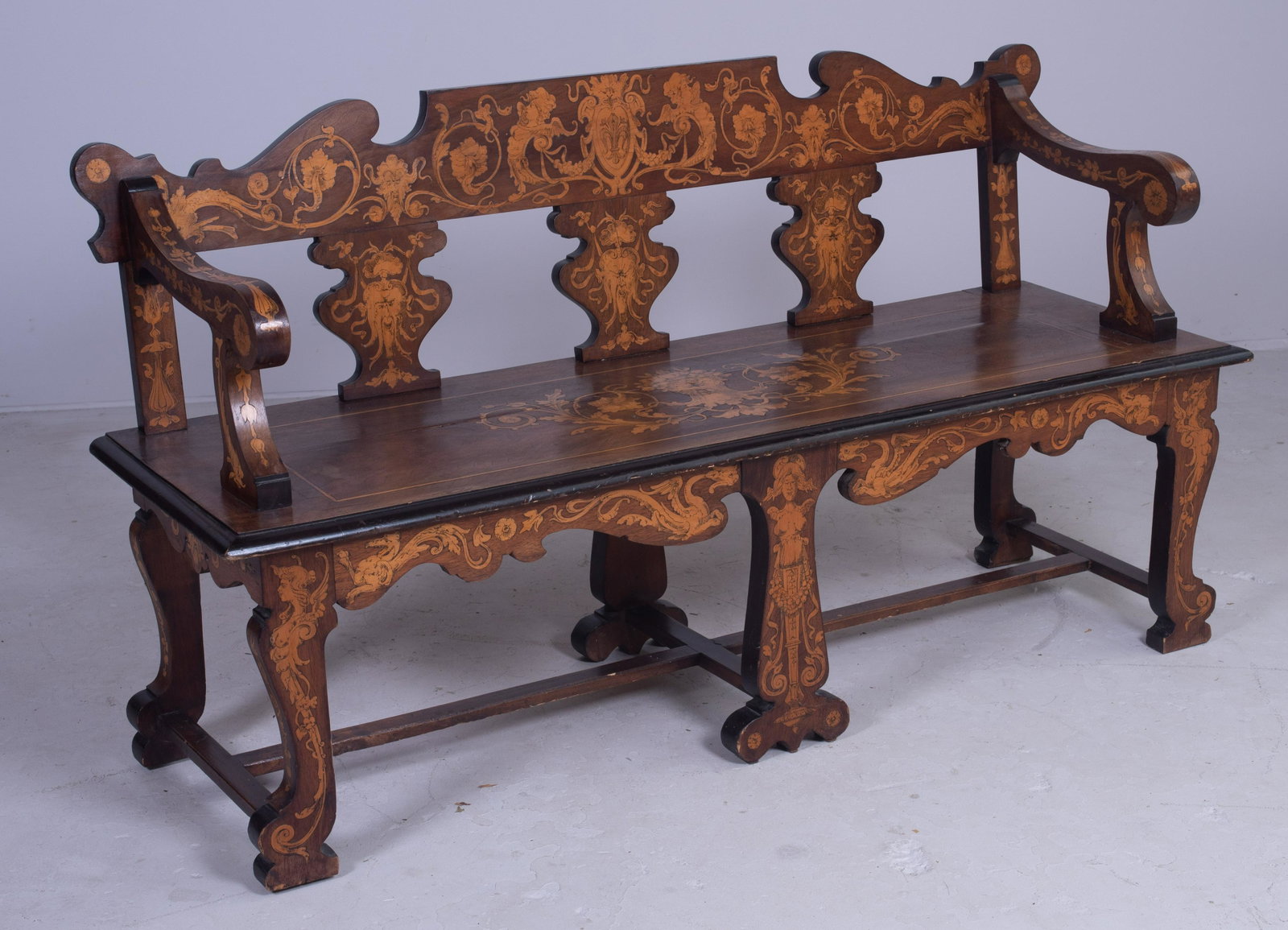 Italian walnut inlaid hall bench: Italian walnut inlaid hall bench, scroll cut back arms, apron and legs, mid 19th c, 30" h x 56" w x 18" d, split in seat