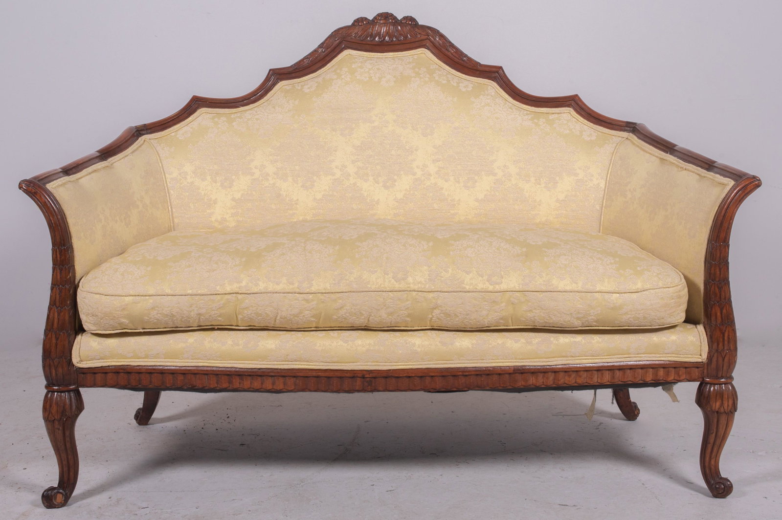 Carved walnut French style settee: Carved walnut French style settee, yellow floral upholstery, 37" h x 55" w x 28" d