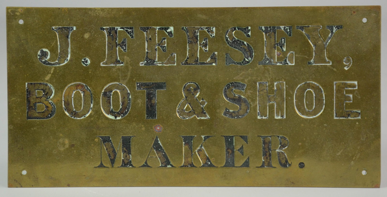 Hand Engraved Brass Trade Sign: Hand engraved brass trade sign, "J. Feesey, Boot & Shoe Maker", some black paint retained in letter with holes at each corner for hanging, 12"x6"