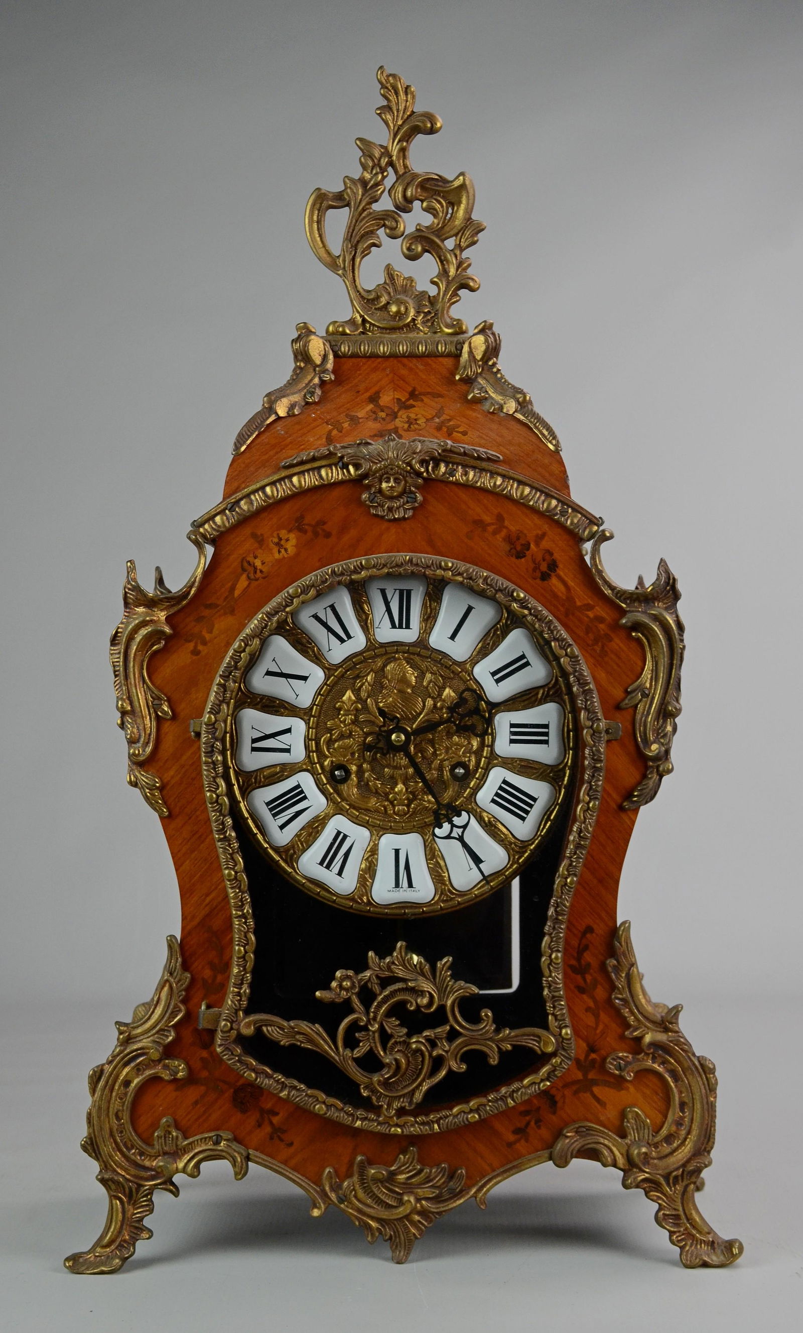 Louis XIV style mantle clock, faux inlaid case, 20th c: Louis XIV style mantle clock, gilt metal mounts on a paint decorated faux inlaid case, German movement, later 20th c, 22" h, with key and pendulum