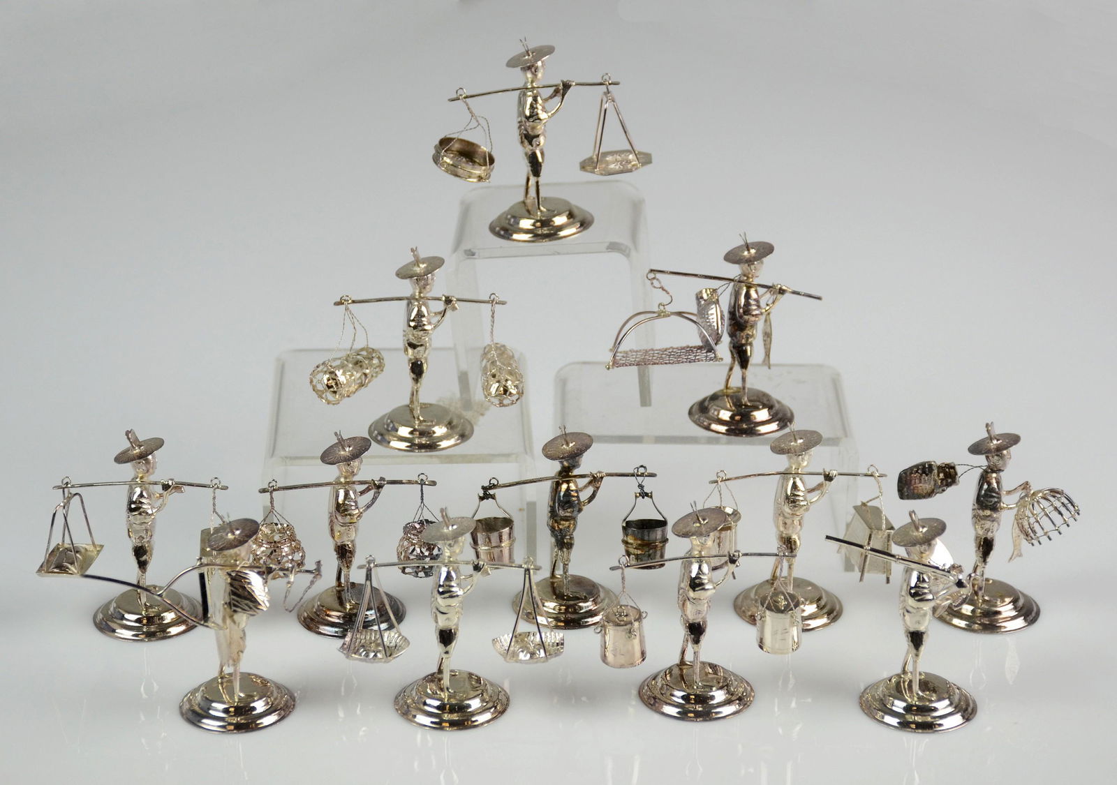 (12) Sterling Figural Fisherman Place Card Holders: Sterling figural fisherman place card holders by 'Sammy Hong Kong' c/o assorted figures carrying sterling baskets, fishing implements, gourds, tea and more, 2-1/4" h , 4.4 T.O