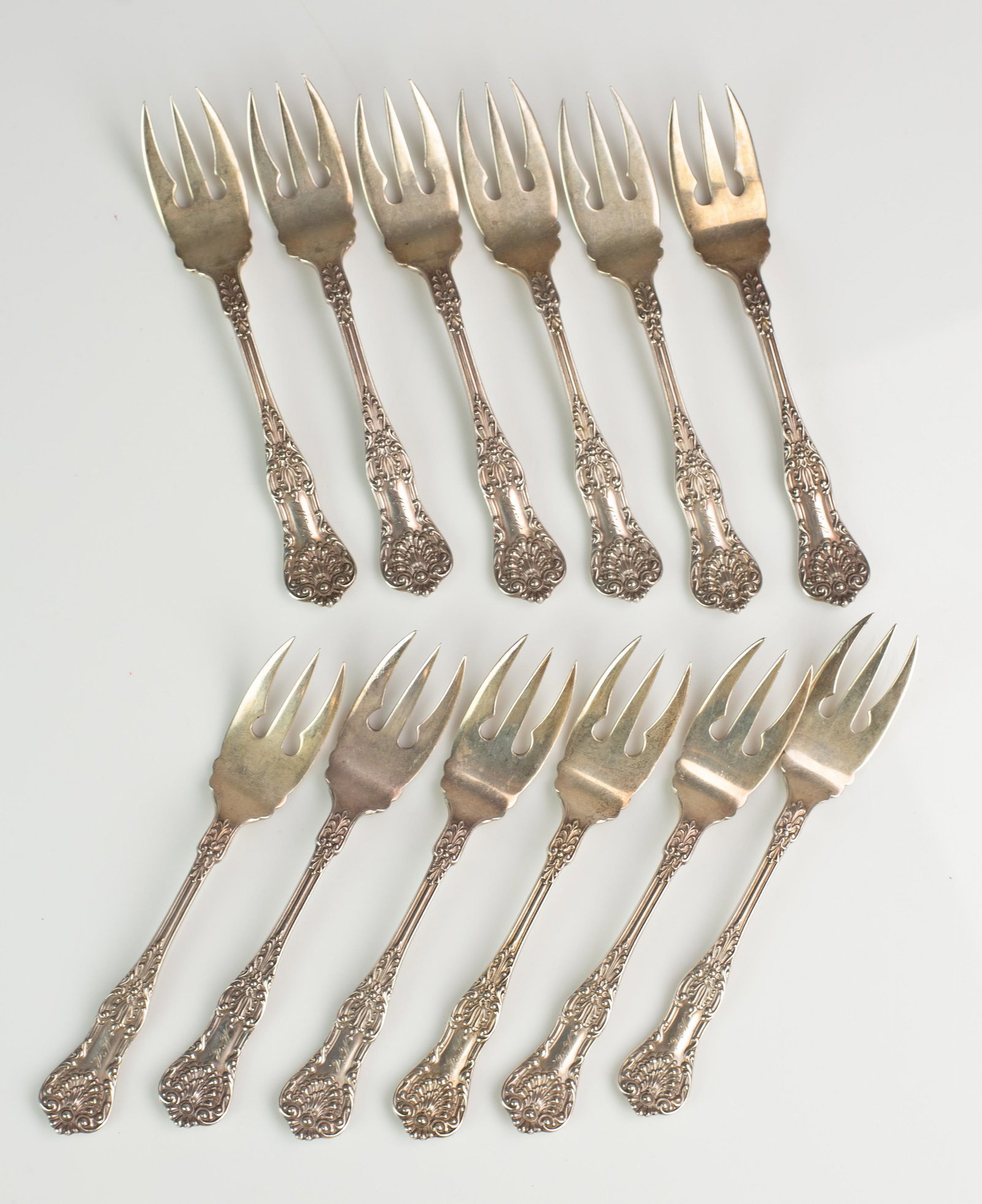 (12) Daniel Low and Co. Sterling Salad Forks: (12) Daniel Low and Co. sterling salad forks with 3 tines, shell decorated handle and 'McC' and handled end, 6", 17.2 T.O
