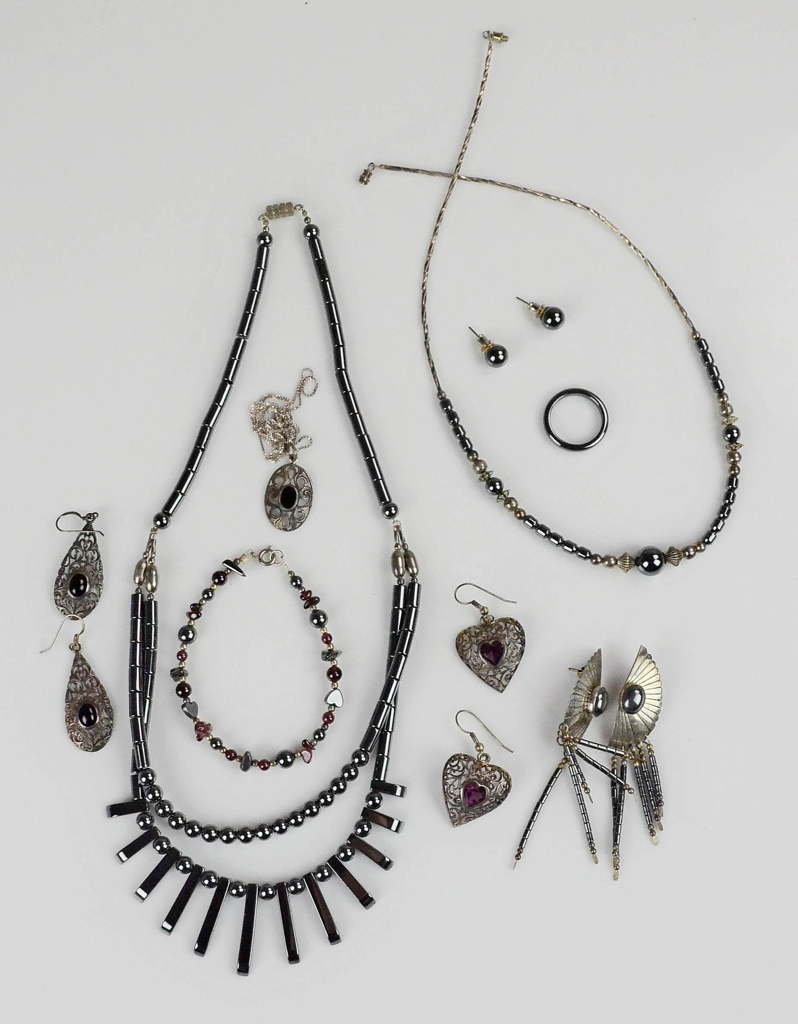 (9) PC Hematite and Silver Jewelry Lot: (9) Pc of Hematite and Silver Jewelry lot C/O; (2) hematite necklaces both are 19" , (1) 7" Beaded hematite and garnet bracelet, (1) TK Sterling Hematite Dangle Earrings, (1) size 7 Hematite ring 3.3m