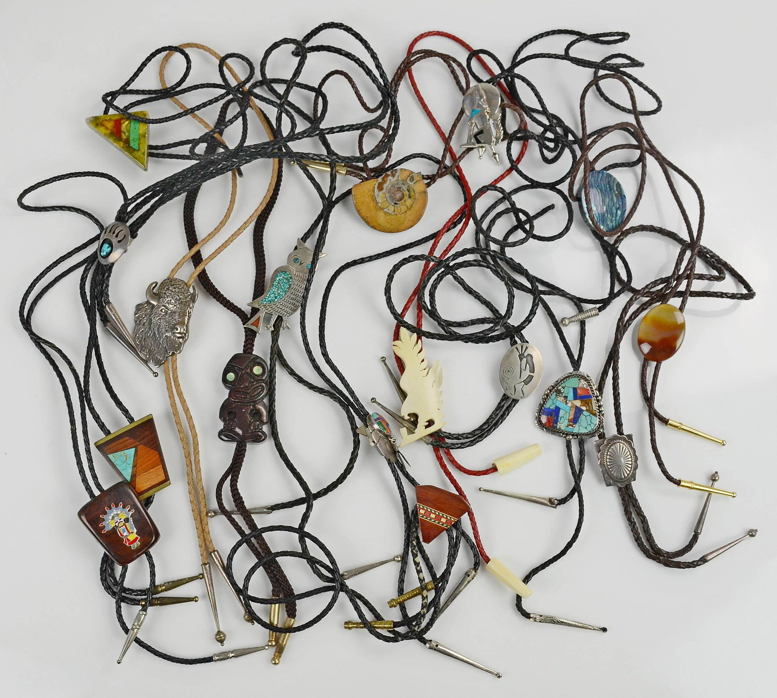 (17) PC Lot of Bolo Ties: (17) Pc Lot of Bolo Ties C/O: (7) Sterling Silver Bolo ties and (4) wooden bolo ties, (1) Bone Bolo tie, (5) Stone Bolo ties one broken.