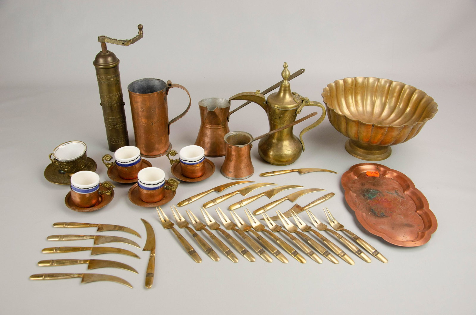 Brass and Copper Grouping: Brass and copper grouping c/o (2) hand hammered copper sauce pots, (1) floral stamped copper cup, (4) demitasse with copper holders, assorted trays, brass coffee pot, brass pepper grinder, footed comp