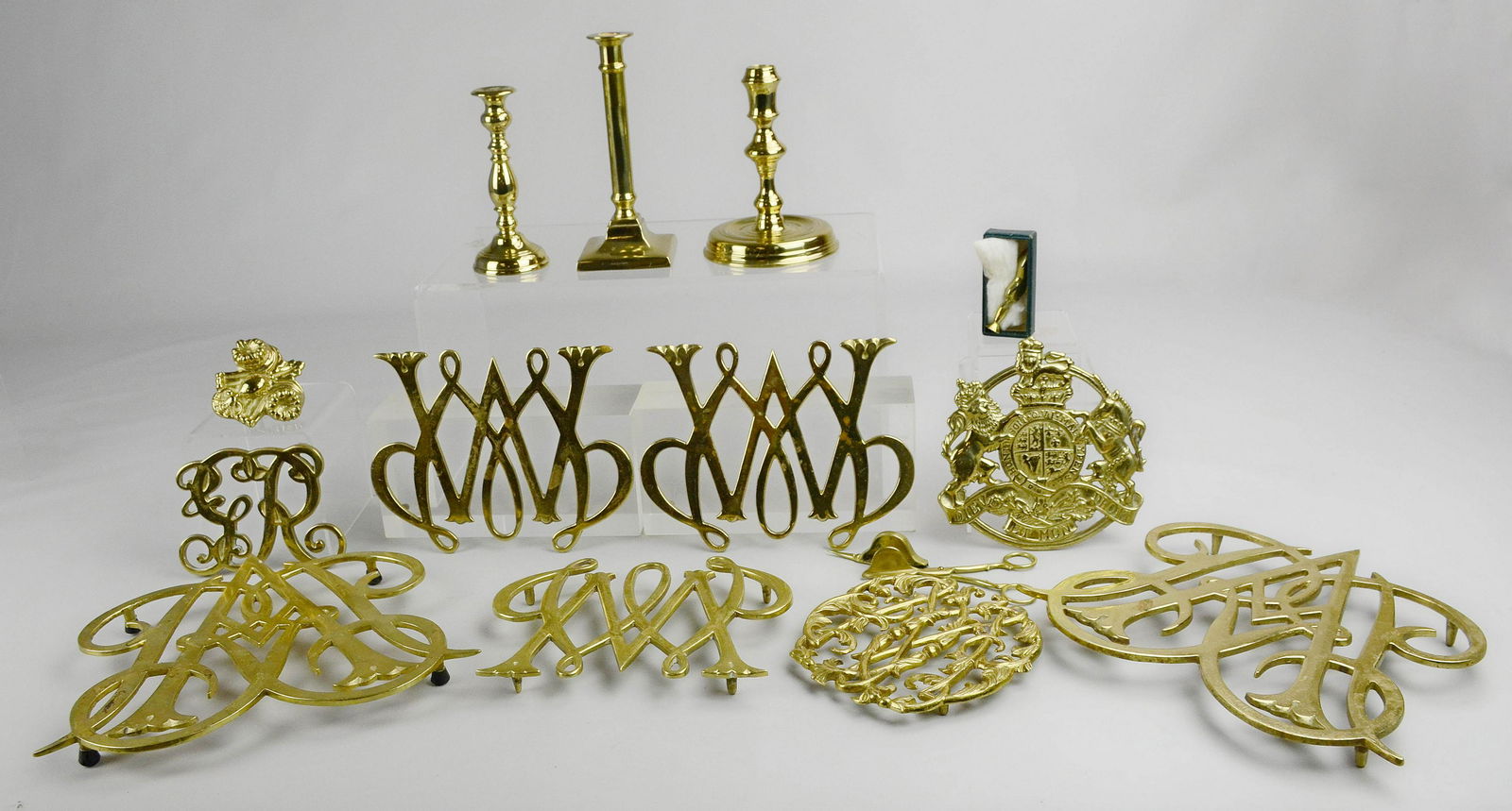 (14) Pcs Colonial Williamsburg Brass: (14) Pcs Colonial Williamsburg brass, including 3 candlesticks, candle shears, 8 trivets, shoe form wax seal, floral ornament with screw back, tallest 7"