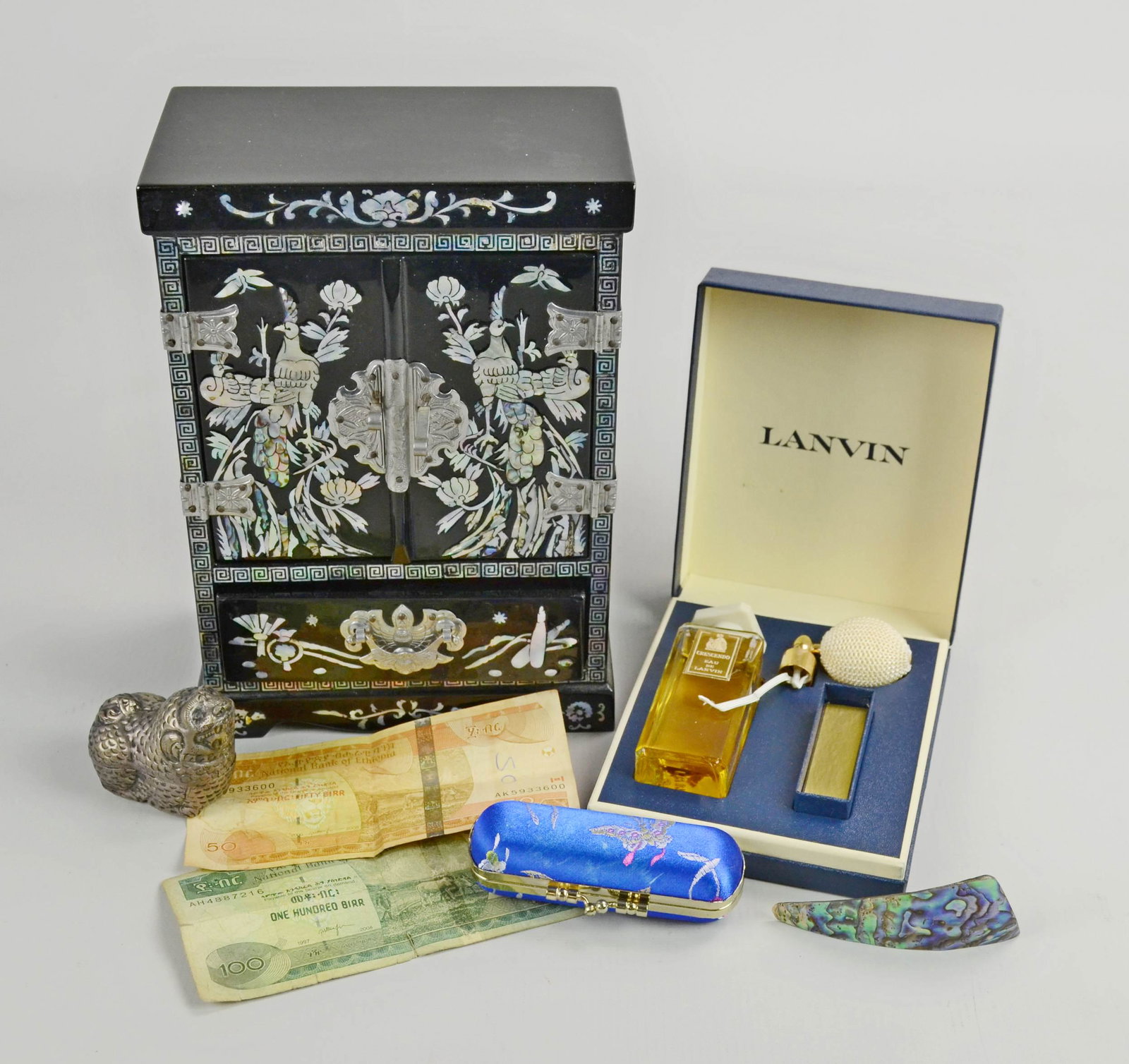(7) Mixed Item Lot chinoiserie Style items: (7) Pc Mixed Item lot C/O; (1) asian themed jewelry box with Mother of Pearl details, missing one drawer, (1) asian themed lipstick case, (1) Mother of Pearl Brooch, (1) Boxed Lanvin Crescendo Parfume